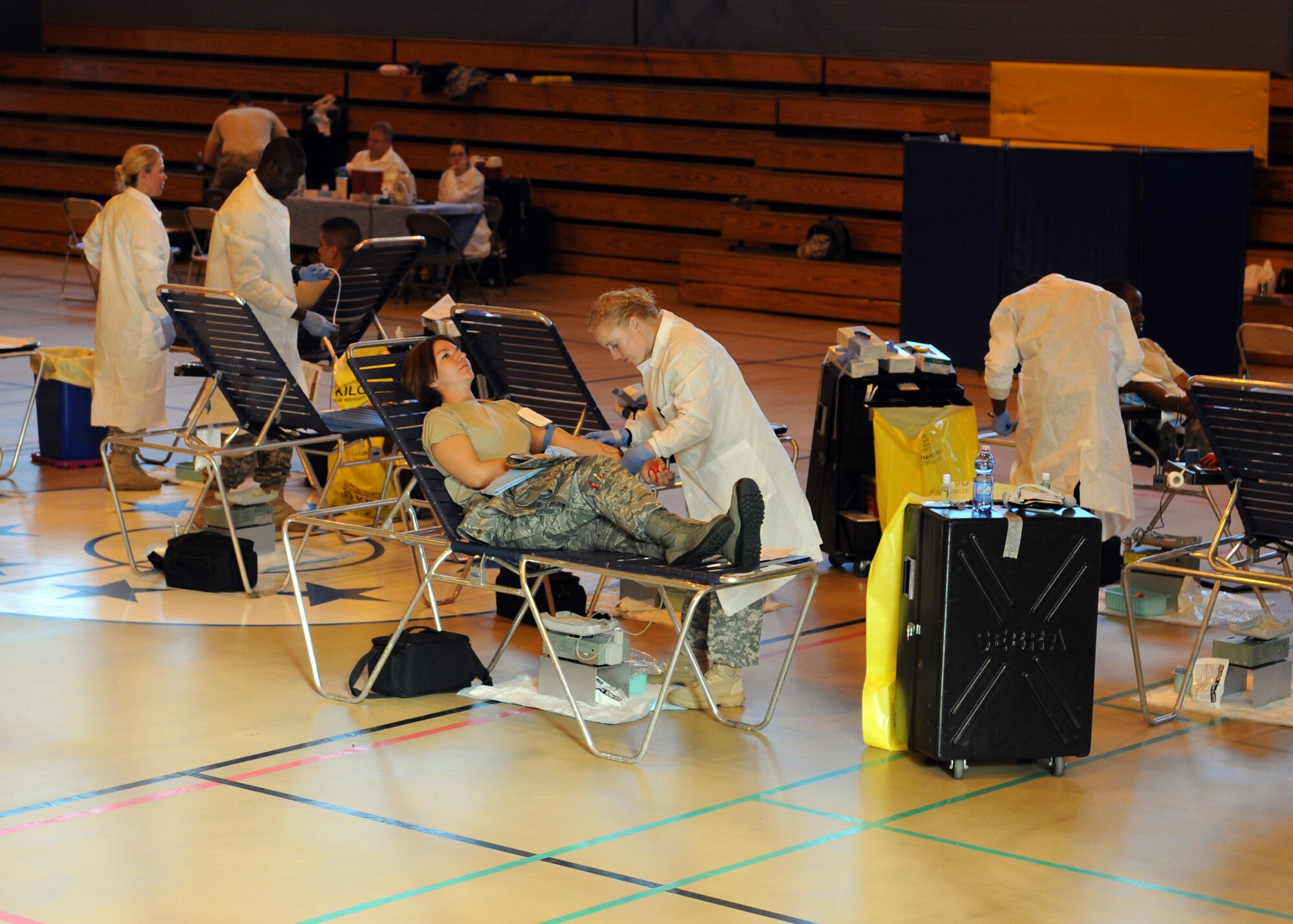 RAF MILDENHALL, England -- Medics from the Landstuhl Regional Medical Center U.S. Army Europe Blood Donor Center draw blood from RAF Mildenhall donors during the Armed Services Blood Program Blood Drive here Sept. 13, 2011.  The ASBP plays a key role in providing quality blood products for Service members and their families in both peace and war time. The drive continues Sept. 14 at the RAF Lakenheath main gym from 8 a.m. to 5 p.m. (U.S. Air Force photo by Staff Sgt. Tabitha M. Lee)