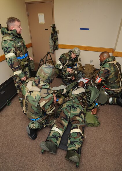Airmen from the 22nd Medical Group assist a mortar attack “victim” during the operational readiness exercise Sept. 10, 2011, McConnell Air Force Base, Kan.  Approximately 300 Team McConnell Airmen participated in the two-day exercise in preparation for an upcoming operational readiness inspection. (U.S. Air Force photo by Senior Airman Maria A. Ruiz)