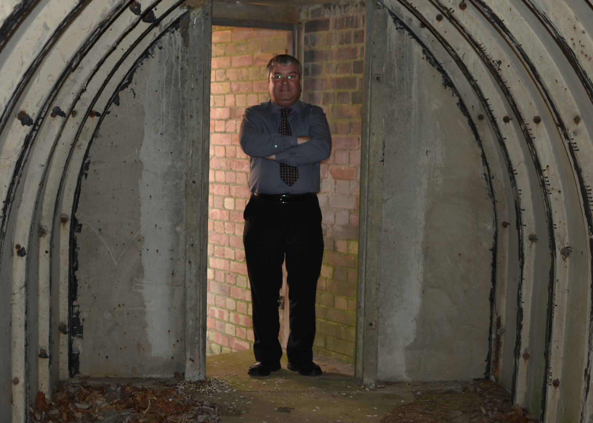 RAF CROUGHTON, United Kingdom - Kevin Bartof stands inside the shelter of one of the World War II fighter pens here. The shelters could hold 25 aircrew and provided shelter during Nazi air raids. (U.S. Air Force photo by Senior Airman Joel Mease)