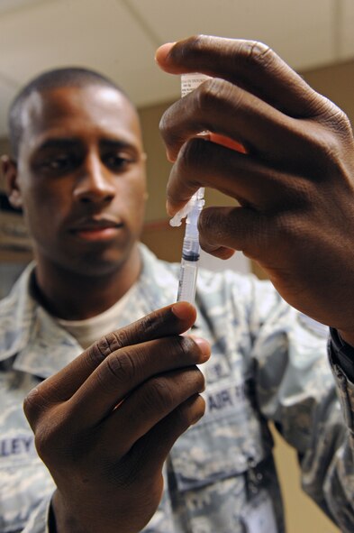 Staff Sgt. Rashad Holley an immunization technician with the 2nd Medical Operations Squadron draws back the plunger of a needle in the medical clinic on Barksdale Air Force Base, La., Sept. 9. Prior to enrolling students in kindergarten, schools require children to have Diptheria, Tetanus, Pertussis, Polio, Measles, Mumps, Rubella and Varicella immunizations up to date. (U.S. Air Force photo/Airman 1st Class Micaiah Anthony)(RELEASED)