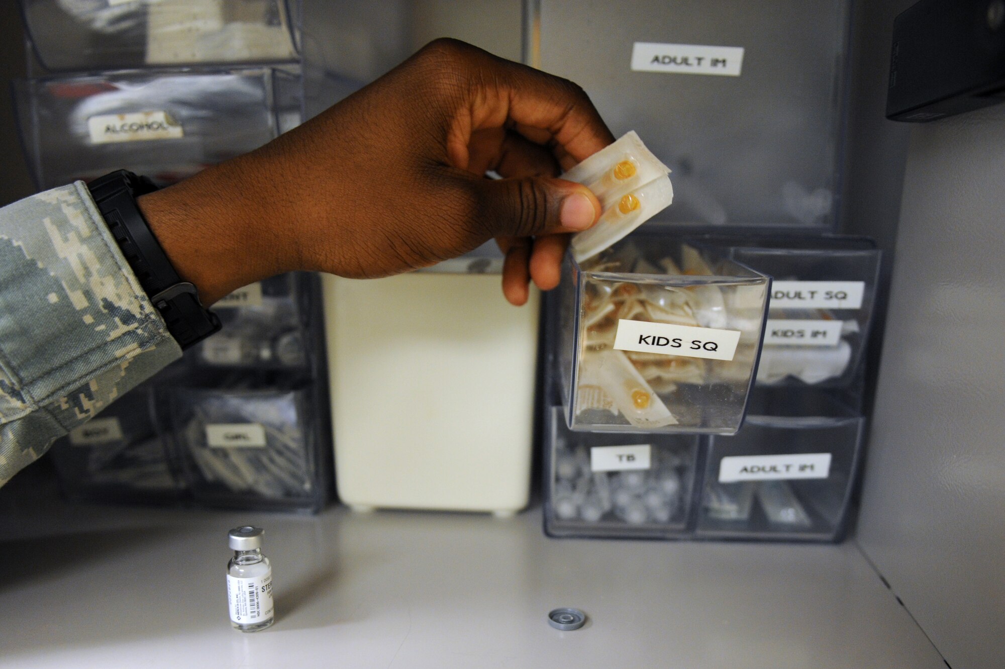 Staff Sgt. Rashad Holley an immunization technician with the 2nd Medical Operations Squadron removes an intramuscular needle from a box in the medical clinic on Barksdale Air Force Base, La., Sept. 9. Prior to enrolling students in kindergarten, schools require children to have Diptheria, Tetanus, Pertussis, Polio, Measles, Mumps, Rubella and Varicella immunizations up to date. (U.S. Air Force photo/Airman 1st Class Micaiah Anthony)(RELEASED)
