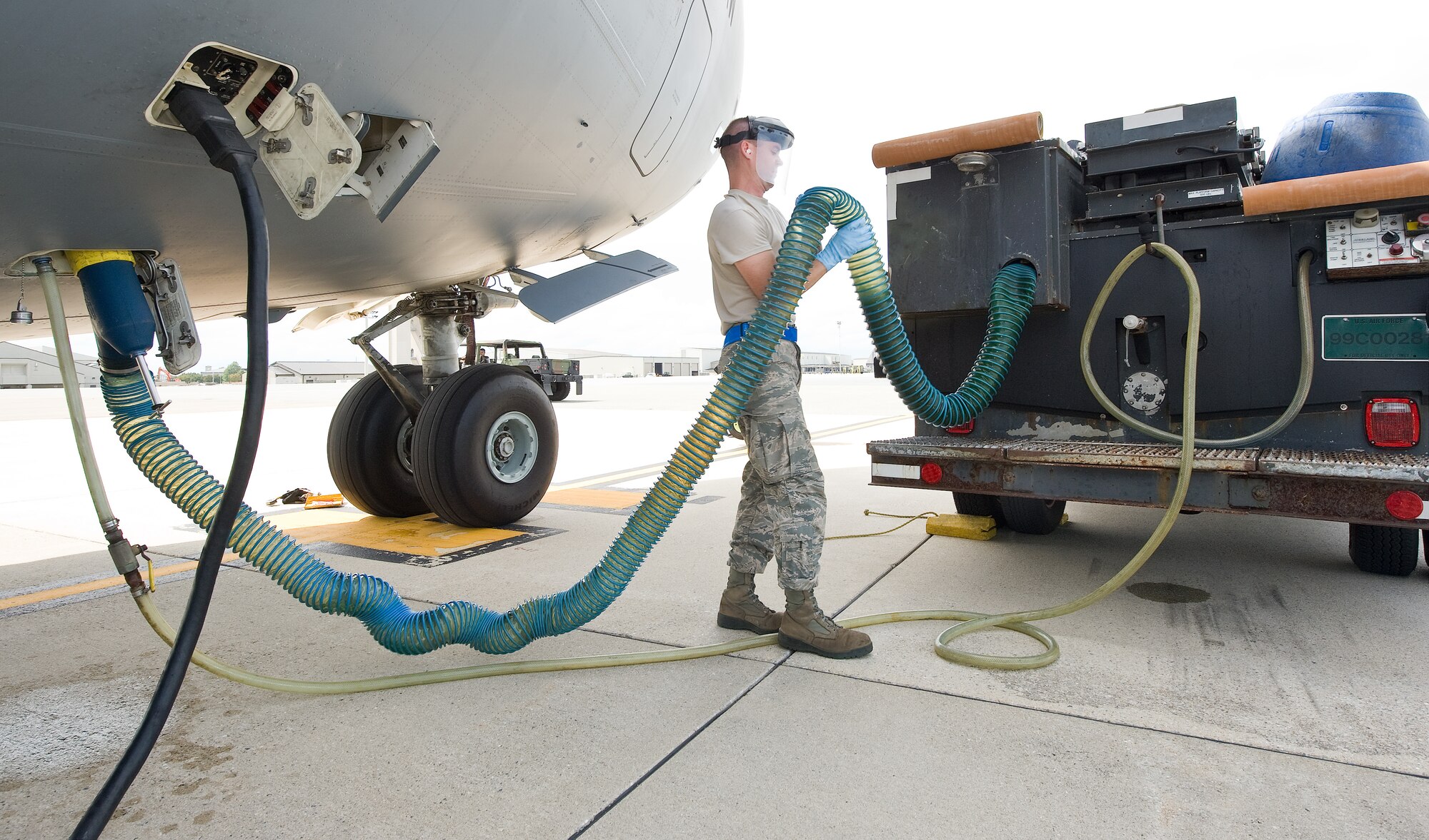 Airman 1st Class Christopher Bell, a ramp specialist with the 436th Aerial Port Squadron, drains waste from a C-17 Globemaster III Sept. 7, 2011, at Dover Air Force Base, Del. The 436 APS ramp services shop loads, unloads, cleans and sanitizes all planes flying to and from Dover AFB. (U.S. Air Force photo by Roland Balik)