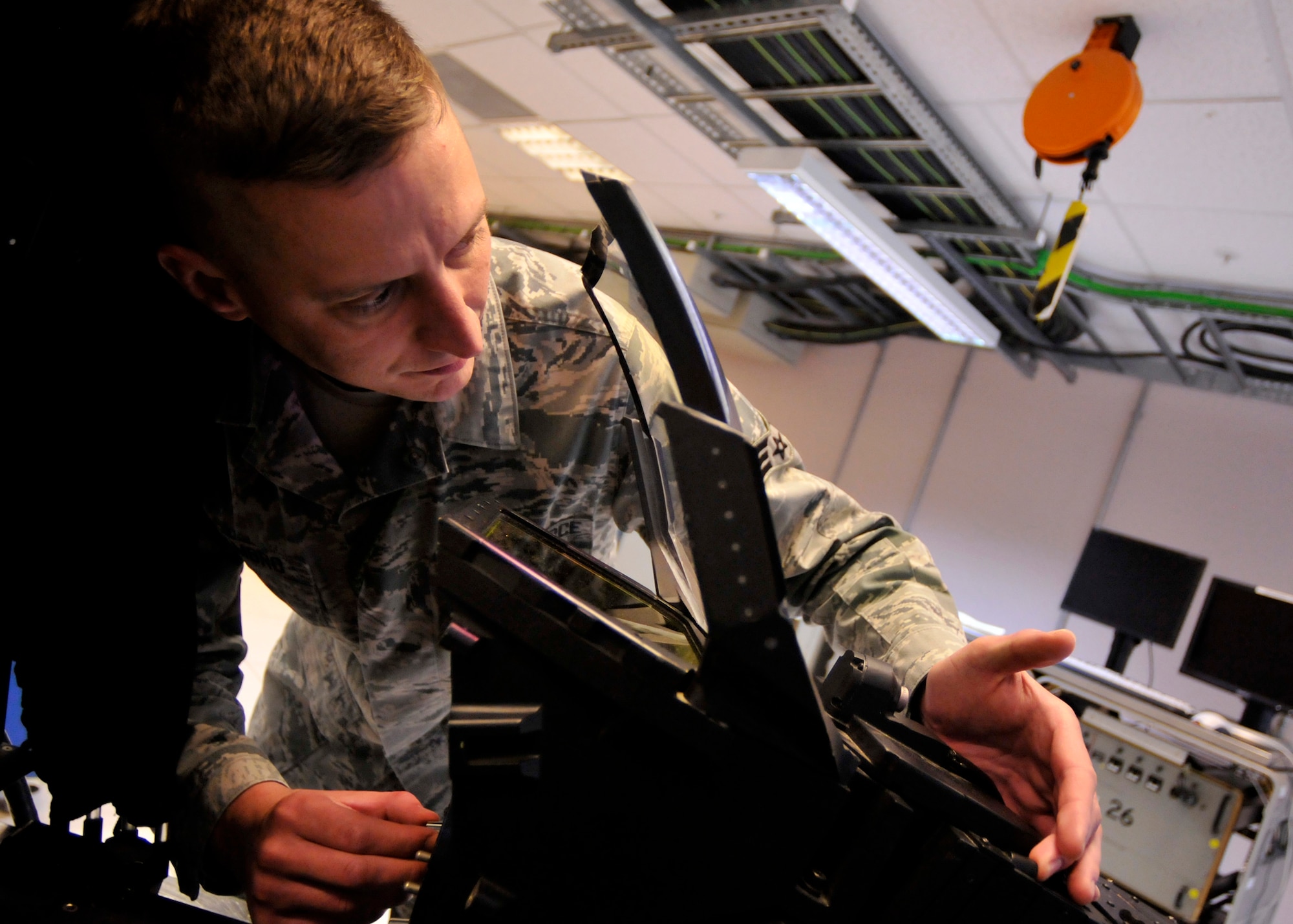 ROYAL AIR FORCE LAKENHEATH, England - Senior Airman Nathan Dimambro, 48th Component Maintenance Squadron Avionics intermediate support section journeyman, performs a function check on a Wide Field of View Heads Up Display from an F-15 at the 48th CMS Avionics Flight AIS building in the Electronic Systems Test Set area, Sept. 7, 2011. AIS Airmen are responsible for providing the flightline with highly effective and efficient intermediate support to maintain the electronics on the F-15s. (U.S. Air Force photo by Senior Airman Tiffany M. Deuel)