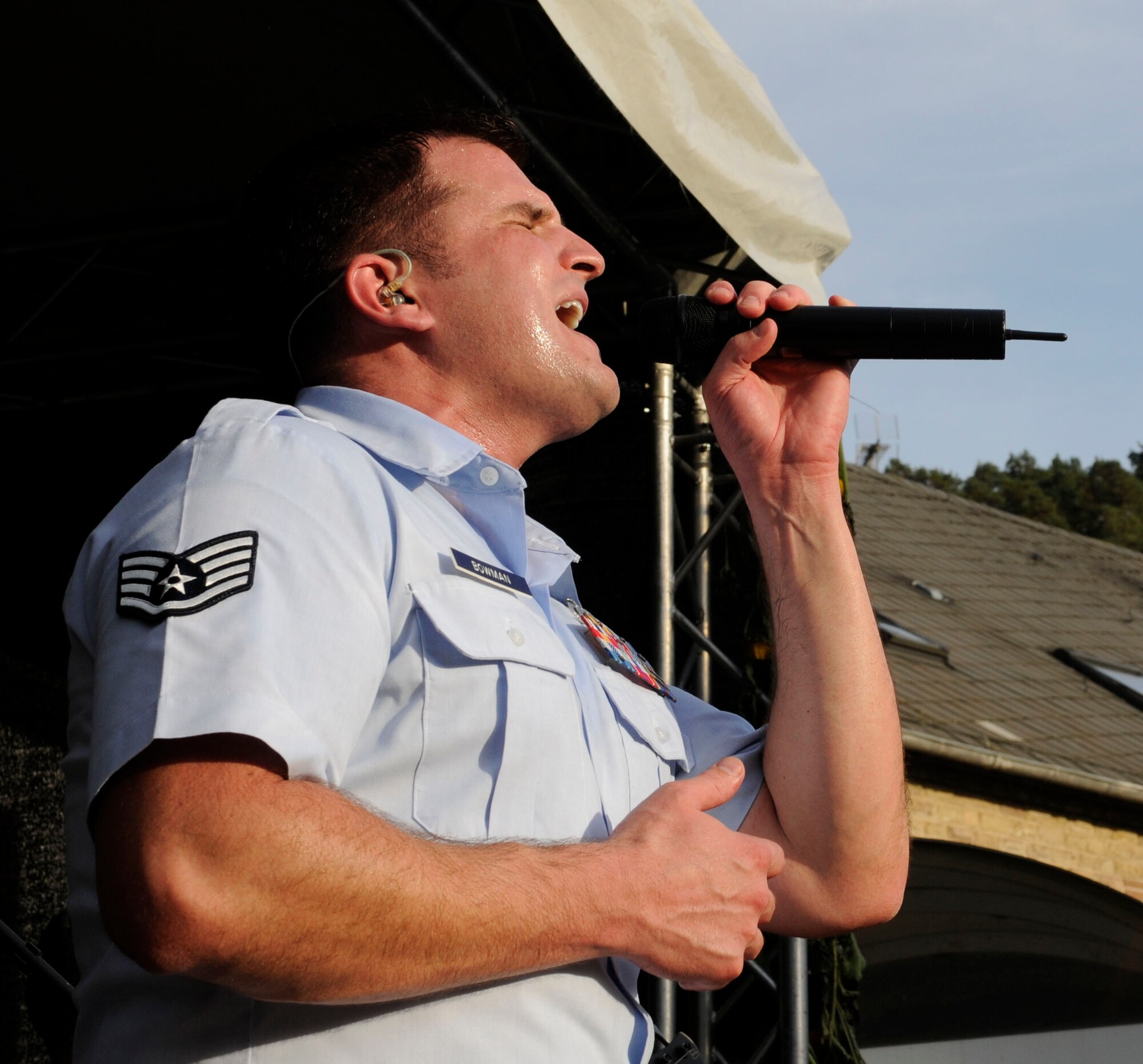NIEDERKAIL, Germany -- Staff Sgt. Craig Bowman, U.S. Air Forces in Europe Band ‘Touch ‘n Go’ vocalist, sings during a performance at Niederkail’s 800th Anniversary Sept. 10 here. The band played rock, country, pop, and rhythm and blues hits as Spangdahlem Airmen and their families celebrated along with community members. (U.S. Air Force photo/ Senior Airman Natasha Stannard)