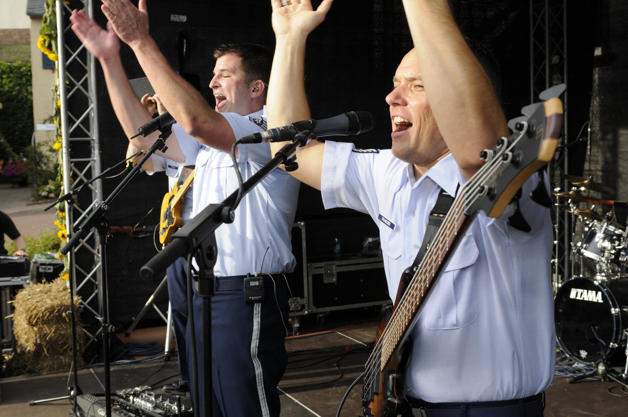 NIEDERKAIL, Germany -- Staff Sgt. Craig Bowman, left, and Tech. Sgt. Mark Frandsen, both members of the U.S. Air Forces in Europe Band ‘Touch ‘n Go’ chant with the crowd during Niederkail’s 800th Anniversary Sept. 10 here.  The band played rock, country, pop, and rhythm and blues hits as Spangdahlem Airmen and their families celebrated along with community members. (U.S. Air Force photo/ Senior Airman Natasha Stannard)