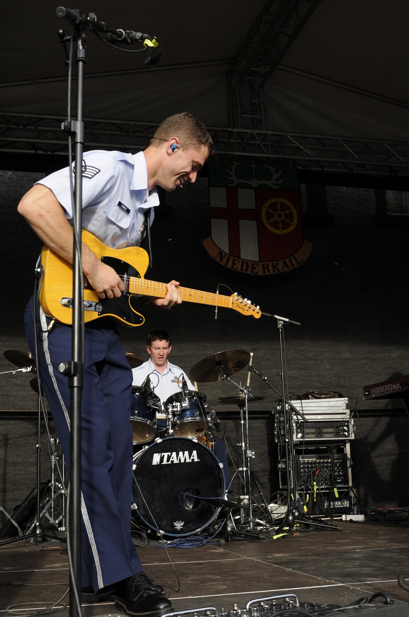 NIEDERKAIL, Germany--Staff Sgt. Dustin Trimble, U.S. Air Forces in Europe Band ‘Touch ‘n Go’ guitarist, plays guitar as Staff Sgt. Robert Browning plays drums during Niederkail’s 800th Anniversary Sept. 10 here. The band played rock, country, pop, and rhythm and blues hits as Spangdahlem Airmen and their families celebrated along with community members. (U.S. Air Force photo/ Senior Airman Natasha Stannard)