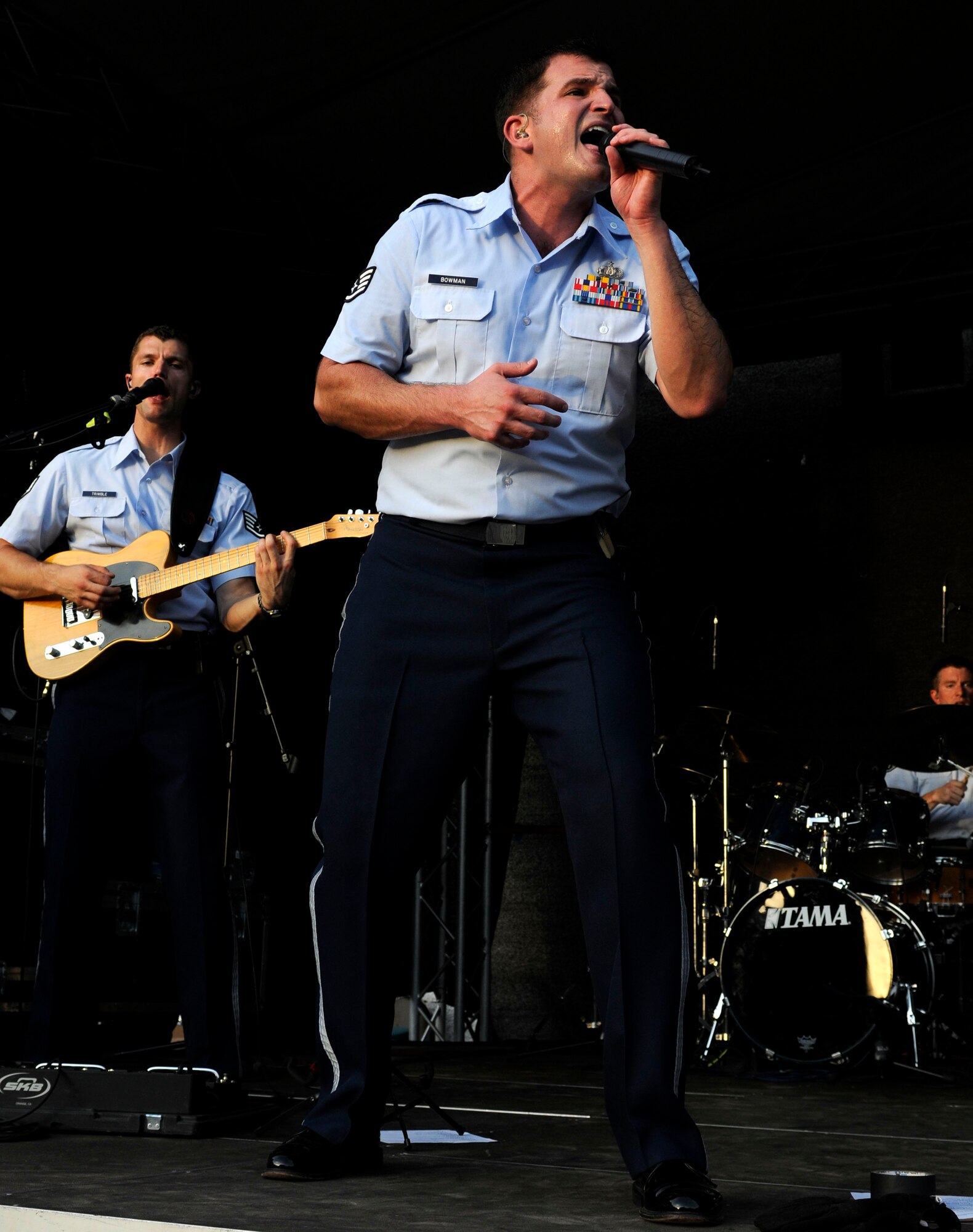 NIEDERKAIL, Germany--Staff Sgt. Craig Bowman, U.S. Air Forces in Europe Band ‘Touch ‘n Go’ vocalist, belts out Lady Gaga’s ‘Bad Romance’ during a performance at Niederkail’s 800th Anniversary Sept. 10 here. The band played rock, country, pop, and rhythm and blues hits as Spangdahlem Airmen and their families celebrated along with community members. (U.S. Air Force photo/ Senior Airman Natasha Stannard)