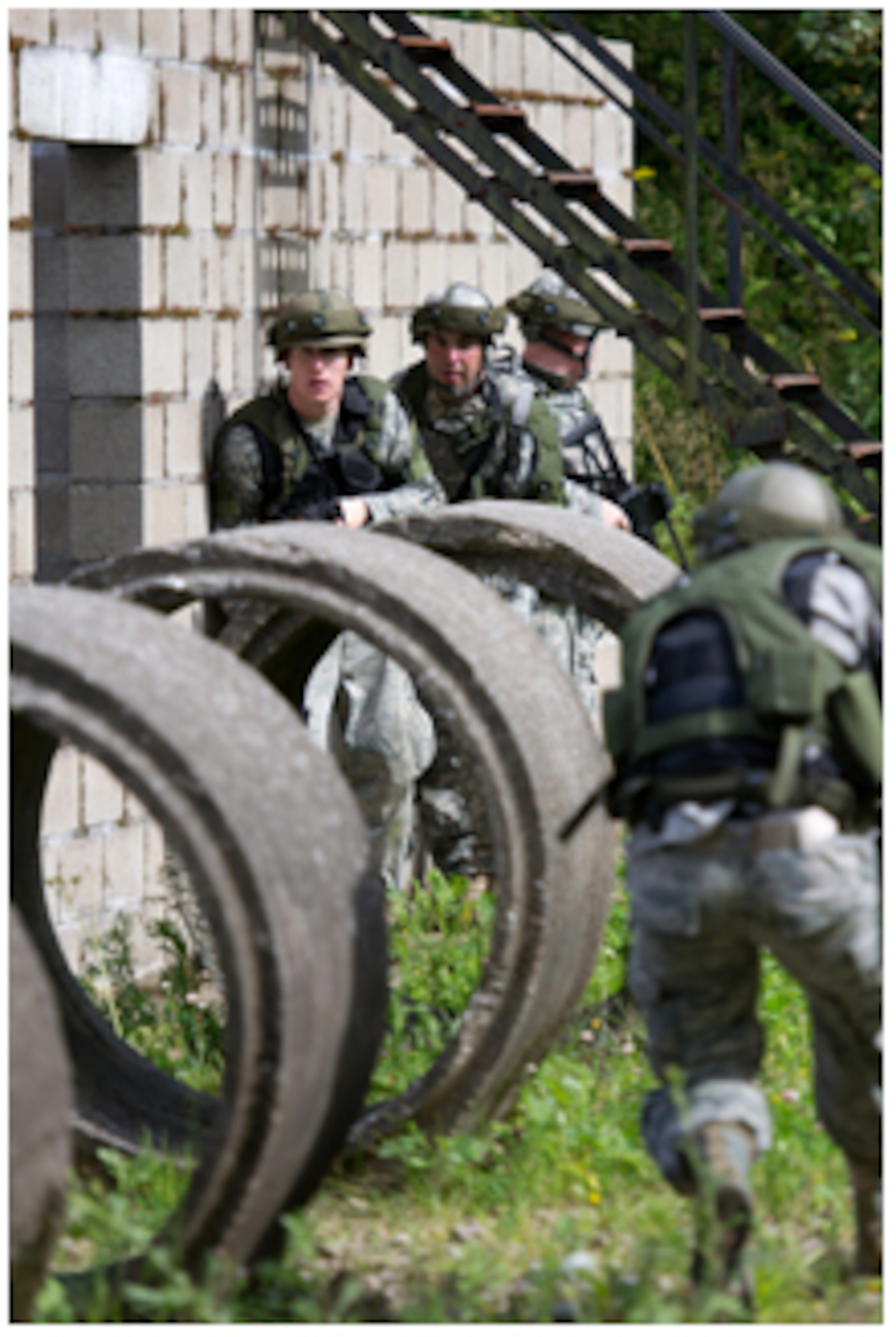 Tech. Sgt John Willliams and Army Pfc. Justin Jonquil prepare to take down a high value target during an exercise at Camp Elsenborn, Belgium August 17.Soldiers and Airmen of the U.S. Army Garrison Benelux, 39th Signal Battalion, 786th Force Support Squadron Det 3 and the USAF 309th Airlift Squadron teamed up with the German Bundeswehr for the training event. (US Army photo by Sgt. Brian Oliver)