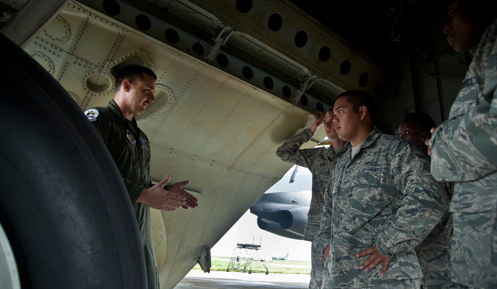ANDERSEN AIR FORCE BASE, Guam—U.S. Air Force Capt. Joshua Logie, 20th Expeditionary Bomber Squadron B-52 Stratofortress pilot, explains the landing gear on a B-52 Stratofortress bomber during a Pacific Airpower Tour here, Sep. 8.  The Pacific Airpower Tour is designed to give Airmen from Andersen a broad view of what the base does for the Air Force in the Pacific Asian theater.  (U.S. Air Force photo by Senior Airman Benjamin Wiseman/Released)