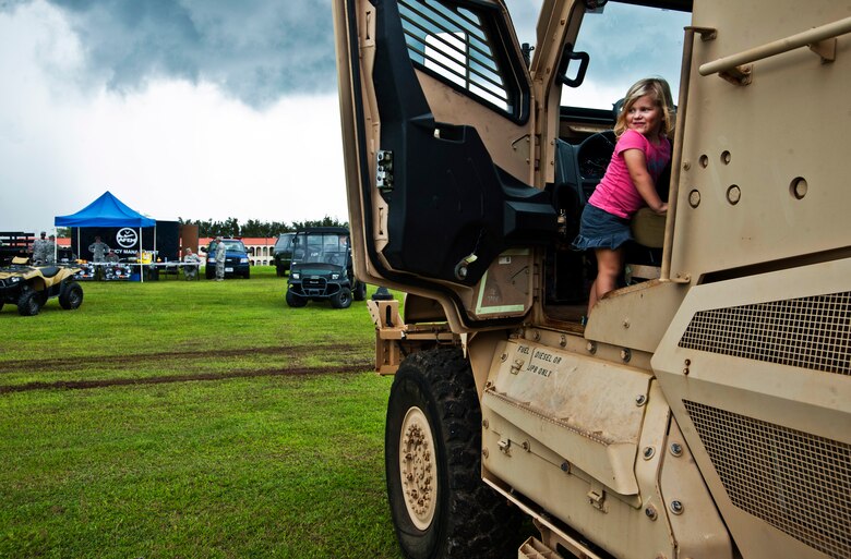 ANDERSEN AIR FORCE BASE, Guam—Skylar Mellan, daughter of Tech. Sgt. Chris Mellan and his wife, Kiley, climbs inside a mine resistant ambush protected vehicle during a showcase for National Preparedness Month here, Sep. 8. Several agencies were on hand demonstrating their capabilities to the Andersen community.  (U.S. Air Force photo by Senior Airman Benjamin Wiseman/Released)