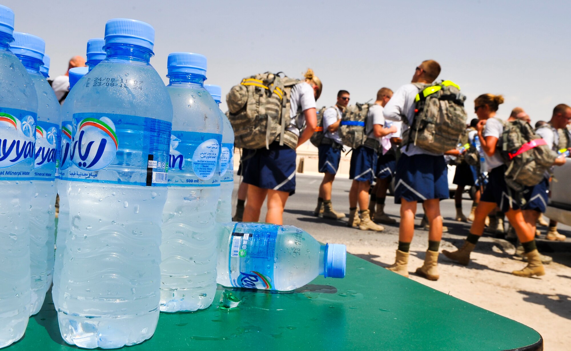Members of the 379th Expeditionary Security Forces Squadron take a water break during their 9.11-mile ruck march Sept. 11, 2011, at an undisclosed location in Southwest Asia. The march was one of three base-wide events to commemorate the nearly 3,000 people, including the 55 military members and 411 emergency personnel, who lost their lives 10 years ago in the tragic events of Sept. 11, 2001. (U.S Air Force photo/Senior Airman Paul Labbe)