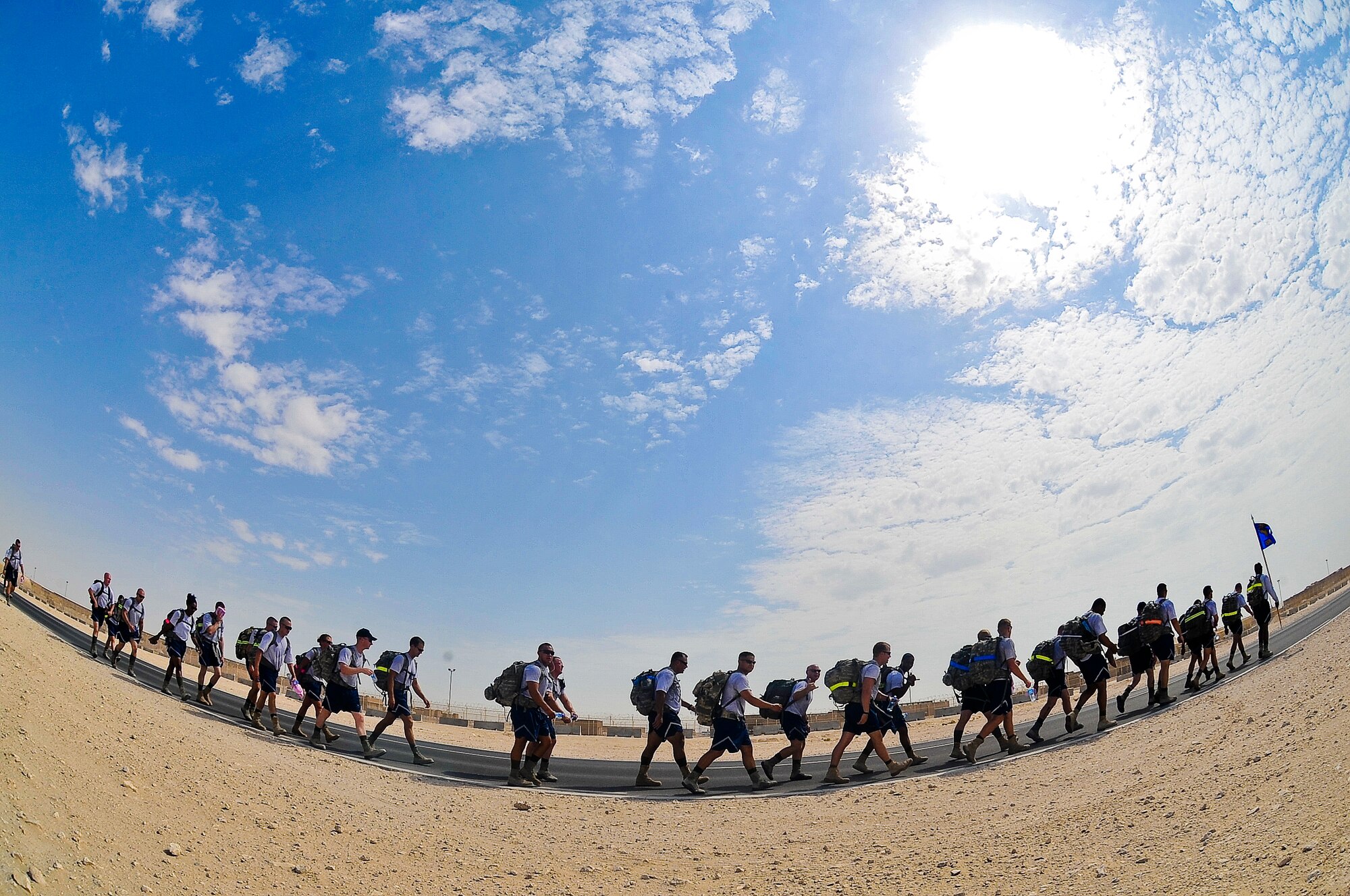 Members of the 379th Expeditionary Security Forces Squadron take part in a 9.11-mile ruck march Sept. 11, 2011, at an undisclosed location in Southwest Asia. The march was one of three base-wide events to commemorate the nearly 3,000 people, including the 55 military members and 411 emergency personnel, who lost their lives 10 years ago in the tragic events of Sept. 11, 2001. (U.S Air Force photo/Senior Airman Paul Labbe)