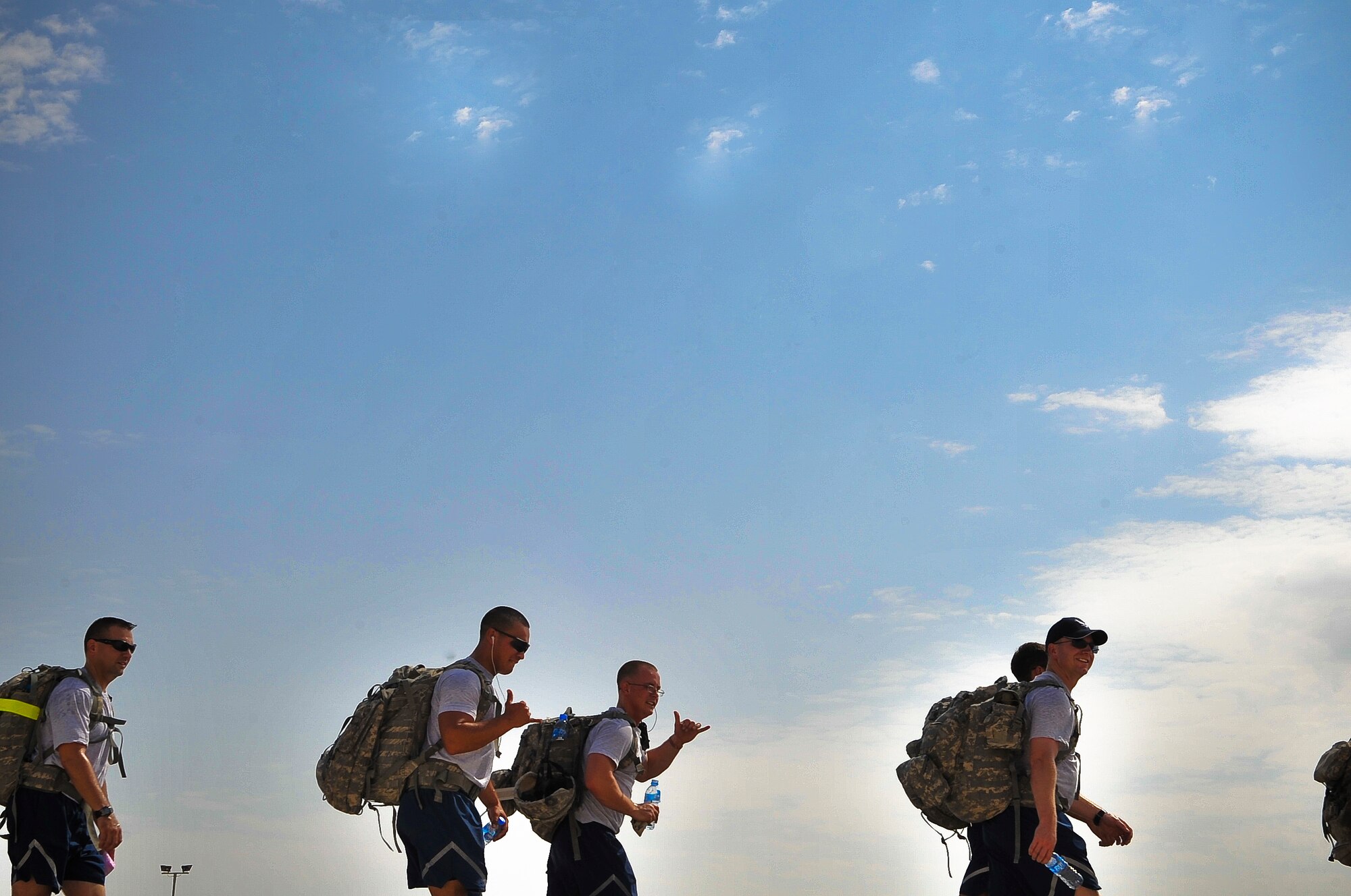 Members of the 379th Expeditionary Security Forces Squadron take part in a 9.11-mile ruck march Sept. 11, 2011, at an undisclosed location in Southwest Asia. The march was one of three base-wide events to commemorate the nearly 3,000 people, including the 55 military members and 411 emergency personnel, who lost their lives 10 years ago in the tragic events of Sept. 11, 2001. (U.S. Air Force photo/Senior Airman Paul Labbe)