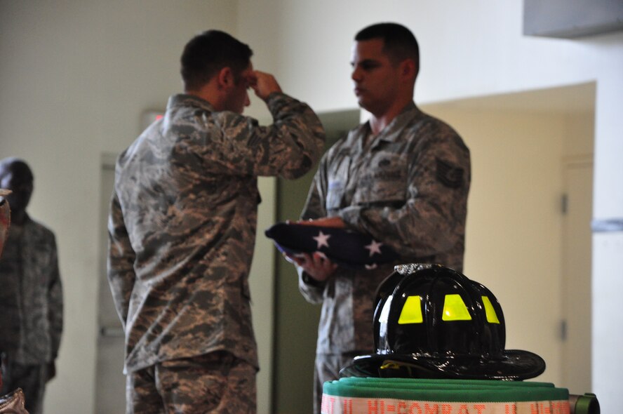 Senior Airman Dustin Boivin and Tech. Sgt. Justin Pederson, both firefighters with the 51st Civil Engineer Squadron, fold a flag Sept. 11, 2011 at Osan Air Base, Republic of Korea. “We will never forget,” is a phrase many Americans have heard thousands of times since Sept. 11, 2001, but for some the words go a bit deeper. The 51st CES fire department held a ceremony to remember and honor the firefighters who lost their lives that fateful day. (U.S. Air Force photo/Tech. Sgt. Chad Thompson)