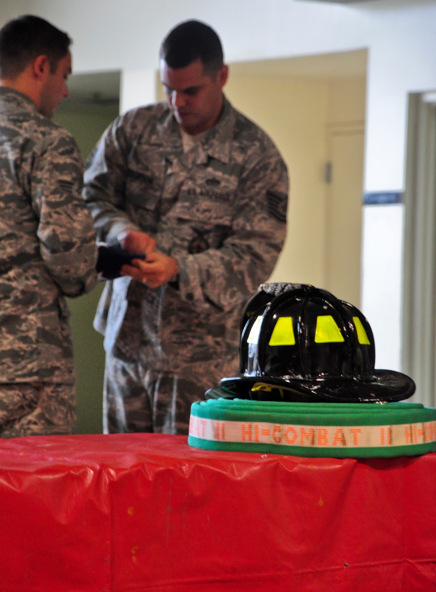 Senior Airman Dustin Boivin and Tech. Sgt. Justin Pederson, both firefighters with the 51st Civil Engineer Squadron, fold a flag Sept. 11, 2011 at Osan Air Base, Republic of Korea. “We will never forget,” is a phrase many Americans have heard thousands of times since Sept. 11, 2001, but for some the words go a bit deeper. The 51st CES fire department held a ceremony to remember and honor the firefighters who lost their lives that fateful day. (U.S. Air Force photo/Tech. Sgt. Chad Thompson)