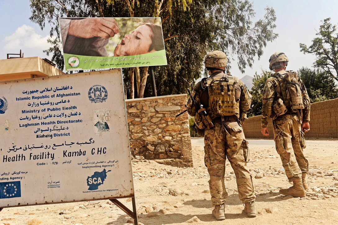 U.S. soldiers post security outside a clinic in the Alisheng district in Afghanistan's Laghman province, Sept. 12, 2011. The soldiers are assigned to the Laghman Provincial Reconstruction Team, which partnered with Afghan police to teach proper patrol procedures and talk with village residents. The soldiers are members of the Rhode Island Army National Guard.