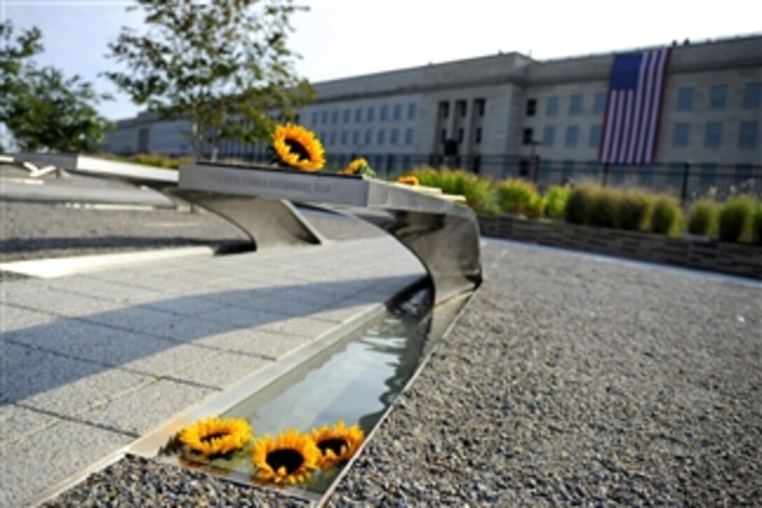 Sunflowers lay on a bench during the remembrance ceremony at the Pentagon Memorial on Sept. 11, 2011.  
