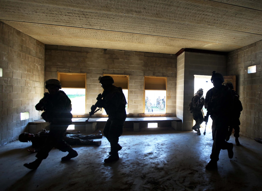 Marines and Sailors with Weapons Platoon, Charlie Company, 1st Battalion, 2nd Marine Regiment, breach a building while conducting Military Operations in Urban Terrain training at the Urban Assault Course on Fort Pickett, Va., Sept. 13. More than 900 Marines and sailors are taking part in the Deployment for Training exercise at Fort Pickett, Sept. 6-23. The battalion is scheduled to attach to the 24th Marine Expeditionary Unit as its Battalion Landing Team a few days after the training.