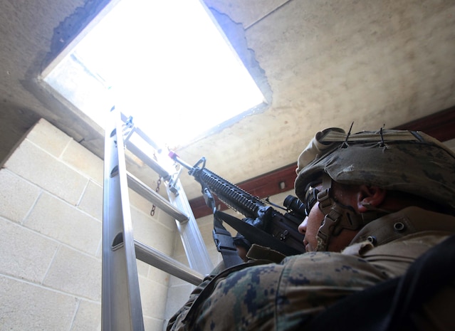 Pfc. Ekrem Uysaler, a team leader with Weapons Platoon, Charlie Company, 1st Battalion, 2nd Marine Regiment, conducts Military Operations in Urban Terrain training at the Urban Assault Course on Fort Pickett, Va., Sept. 13. More than 900 Marines and sailors are taking part in the Deployment for Training exercise at Fort Pickett, Sept. 6-23. The battalion is scheduled to attach to the 24th Marine Expeditionary Unit as its Battalion Landing Team a few days after the training.