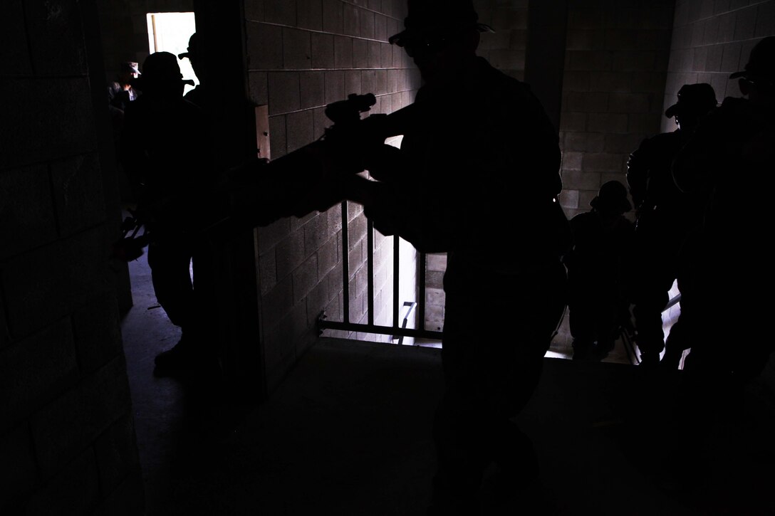 Marines with 1st Platoon, Charlie Company, 1st Battalion, 2nd Marine Regiment, storm a building during Military Operations in Urban Terrain training at the Urban Assault Course on Fort Pickett, Va., Sept. 13, 2011. More than 900 Marines and Sailors are taking part in the Deployment for Training exercise at Fort Pickett, Sept. 6-23. The battalion is scheduled to attach to the 24th Marine Expeditionary Unit as its Battalion Landing Team a few days after the training.