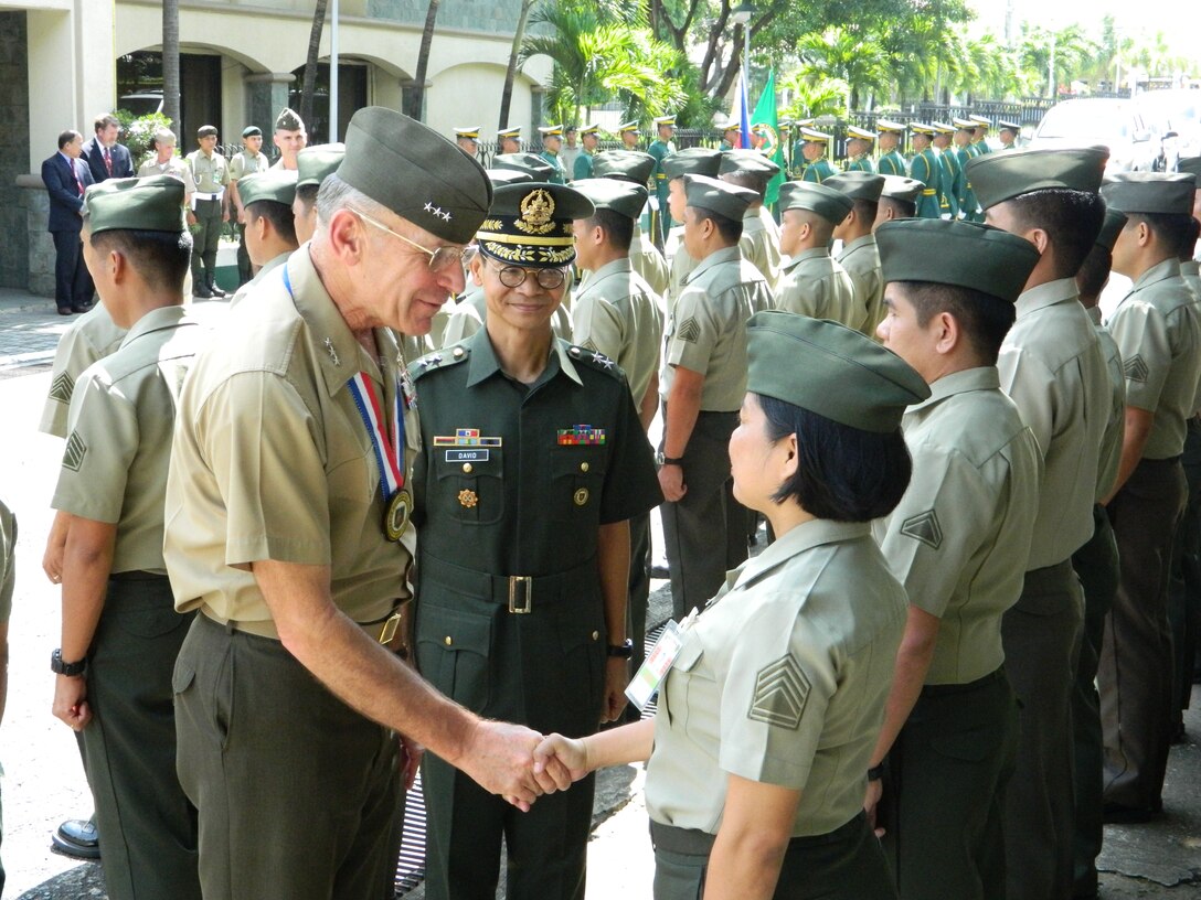 Lt. Gen. Duane D. Thiessen, left, commander of U.S. Marine Corps Forces, Pacific, along with Maj. Gen. Renato David, vice commander of the Philippine Army, greet each soldier in formation during Thiessen’s visit to the Philippines, Sept. 15. During his visit, Thiessen met with the U.S. ambassador, U.S. and Filipino military officials, and component commanders from the Armed Forces of the Philippines.