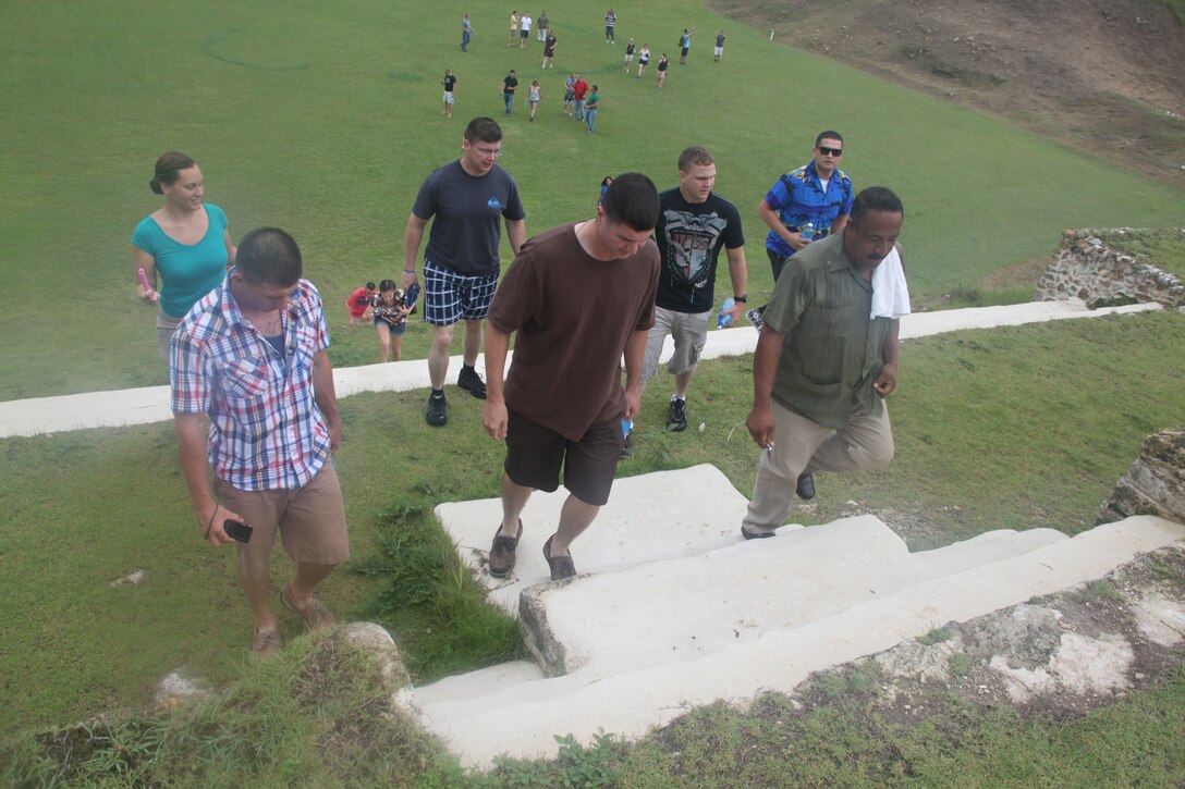 Tour guide Rodolfo E. Thompson leads the Marines of Marine Medium Tiltrotor Squadron 365 and Marine Wing Support Squadron 271 up the stairs of an ancient Mayan ruin at Altun Ha, Belize, Sept. 14, 2011. The morale, welfare and recreation day the Marines had was the first opportunity for many of them to appreciate the ancient Mayan ruins.