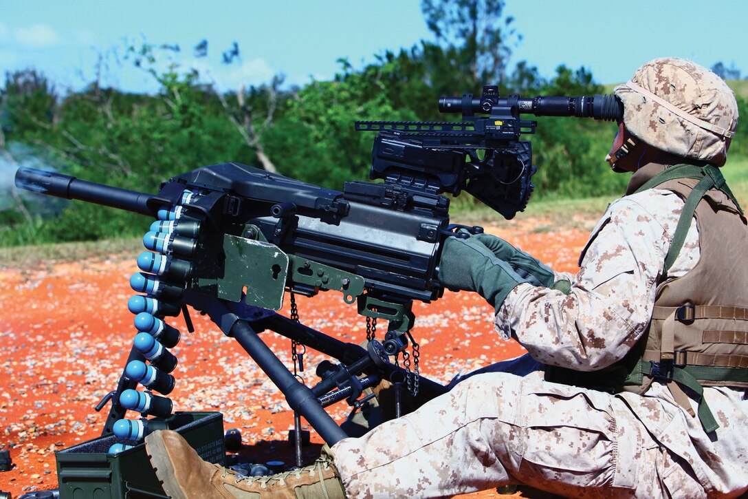 Lance Cpl. Matthew D. Khamsihong, a motor transport operator with III Marine Expeditionary Force Headquarters Group, III MEF, fires the Mk-19 while using a new optic system Aug. 14. The system is designed to increase the weapon's accuracy.