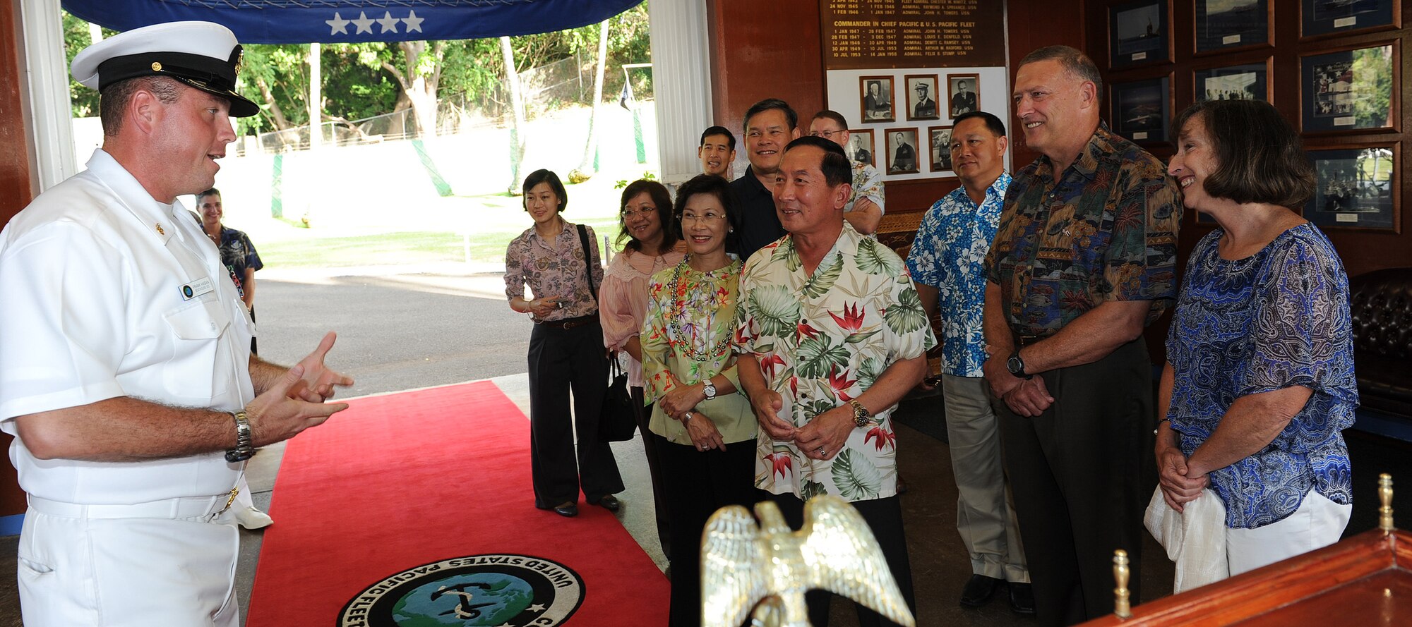 Senior Chief Frank W. Hagan, Pacific Fleet Boathouse officer-in-charge, gives a narrated, guided tour of the historical boathouse to Air Chief Marshal Itthaporn Subhawong, Commander-in-Chief of the Royal Thai Air Force, and spouse Mrs. Napaporn Subhawong, near Ford Island, Hawaii, Sept. 8.  General Gary North, Pacific Air Forces commander, and spouse Mrs. Shelley North accompanied Air Chief Marshal Itthaporn during his tour of Joint Base Pearl Harbor-Hickam. The commander-in-chief also met with General North and other senior leaders from PACAF to discuss common concerns and explore opportunities to strengthen regional cooperation. (U.S. Air Force photo/Tech. Sgt. Jerome S. Tayborn (Released))