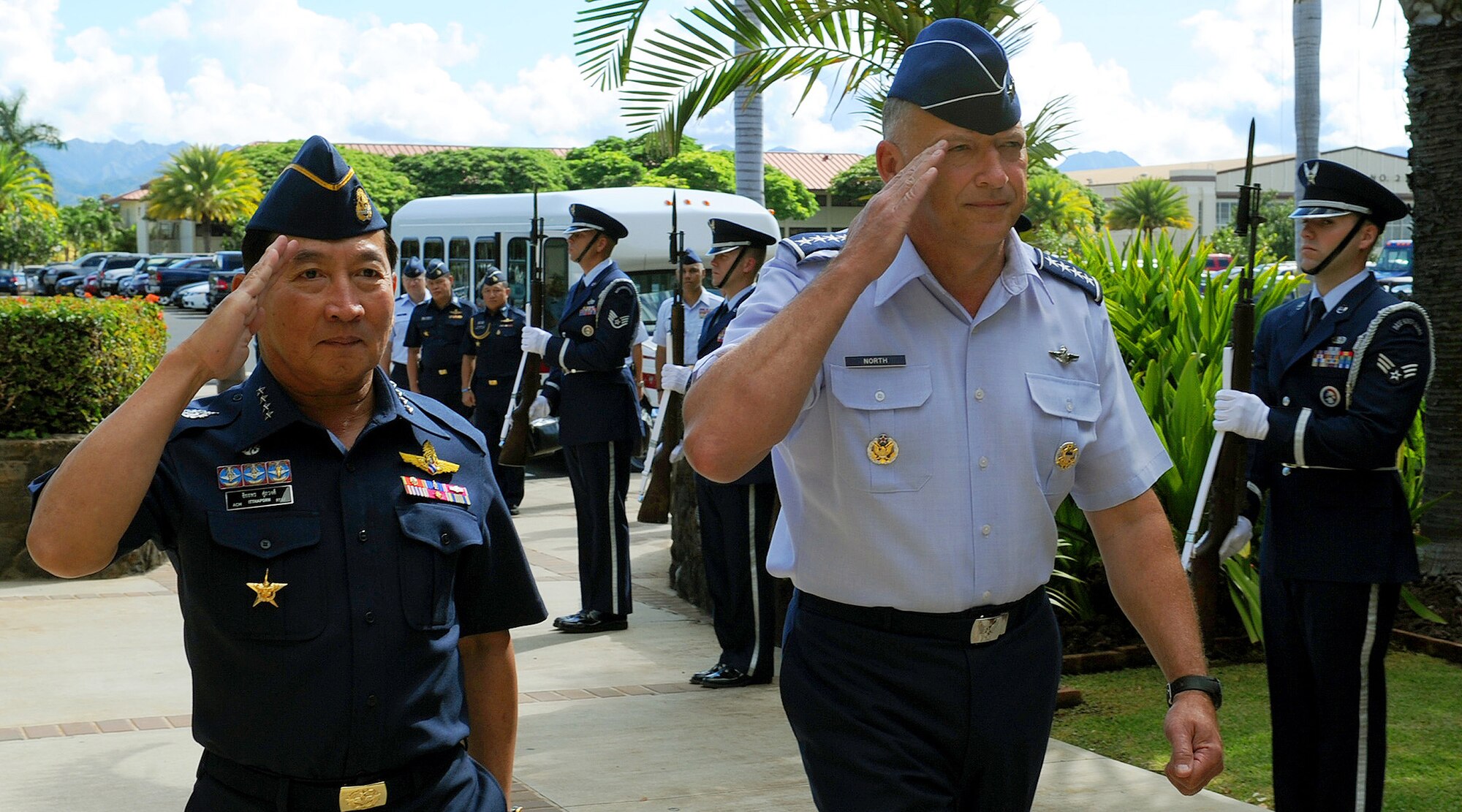 Air Chief Marshal Itthaporn Subhawong, Commander-in-Chief of the Royal Thai Air Force, and General Gary North, Pacific Air Forces commander, salute as they pass through the Joint Base Pearl Harbor-Hickam honor guard cordon at the Pacific Air Forces Headquarters building, Joint Base Pearl Harbor-Hickam, Hawaii, Sept. 7.  Air Chief Marshal Itthaporn visited Hawaii to meet with General North and senior leaders of PACAF to discuss common concerns and explore opportunities to strengthen regional cooperation. (U.S. Air Force photo/Tech. Sgt. Jerome S. Tayborn (Released))