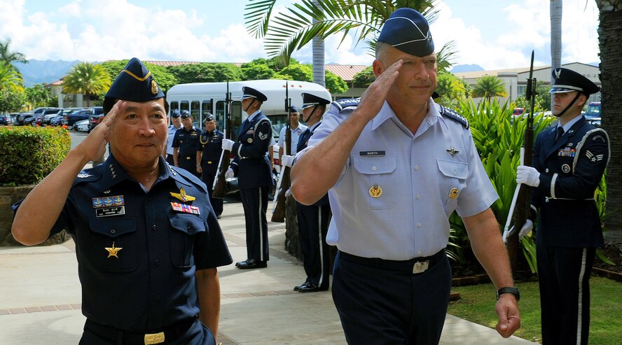 Air Chief Marshal Itthaporn Subhawong, Commander-in-Chief of the Royal Thai Air Force, and General Gary North, Pacific Air Forces commander, salute as they pass through the Joint Base Pearl Harbor-Hickam honor guard cordon at the Pacific Air Forces Headquarters building, Joint Base Pearl Harbor-Hickam, Hawaii, Sept. 7.  Air Chief Marshal Itthaporn visited Hawaii to meet with General North and senior leaders of PACAF to discuss common concerns and explore opportunities to strengthen regional cooperation. (U.S. Air Force photo/Tech. Sgt. Jerome S. Tayborn (Released))