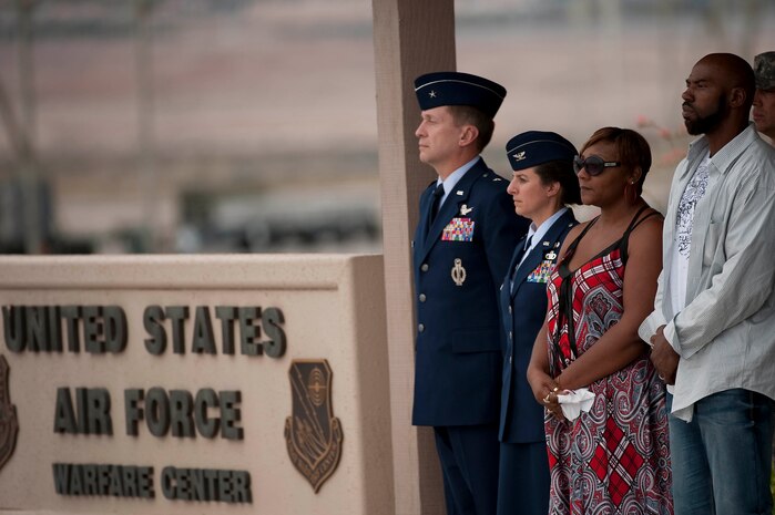 U.S. Air Force Brig. Gen. David J. Buck, U.S. Air Force Warfare Center vice commander, and Col. Carol C. Yannarella, 99th Air Base Wing vice commander, stand with  Rhonda and Aaron Williams while waiting for their nephew U.S. Army Spc. Dennis James Jr., to arrive at Nellis Air Force Base Nev., Sept. 13, 2011. James was deployed to Afghanistan from the 10th Mountain Division at Fort Polk, La. when he was killed by an improvised explosive device, Aug. 31, 2011. James will be entered into the Southern Nevada Veteran Memorial Cemetery Sept. 26, 2011 at Boulder City, Nev.(U.S. Air Force photo by Tech. Sgt. Michael R. Holzworth/Released)