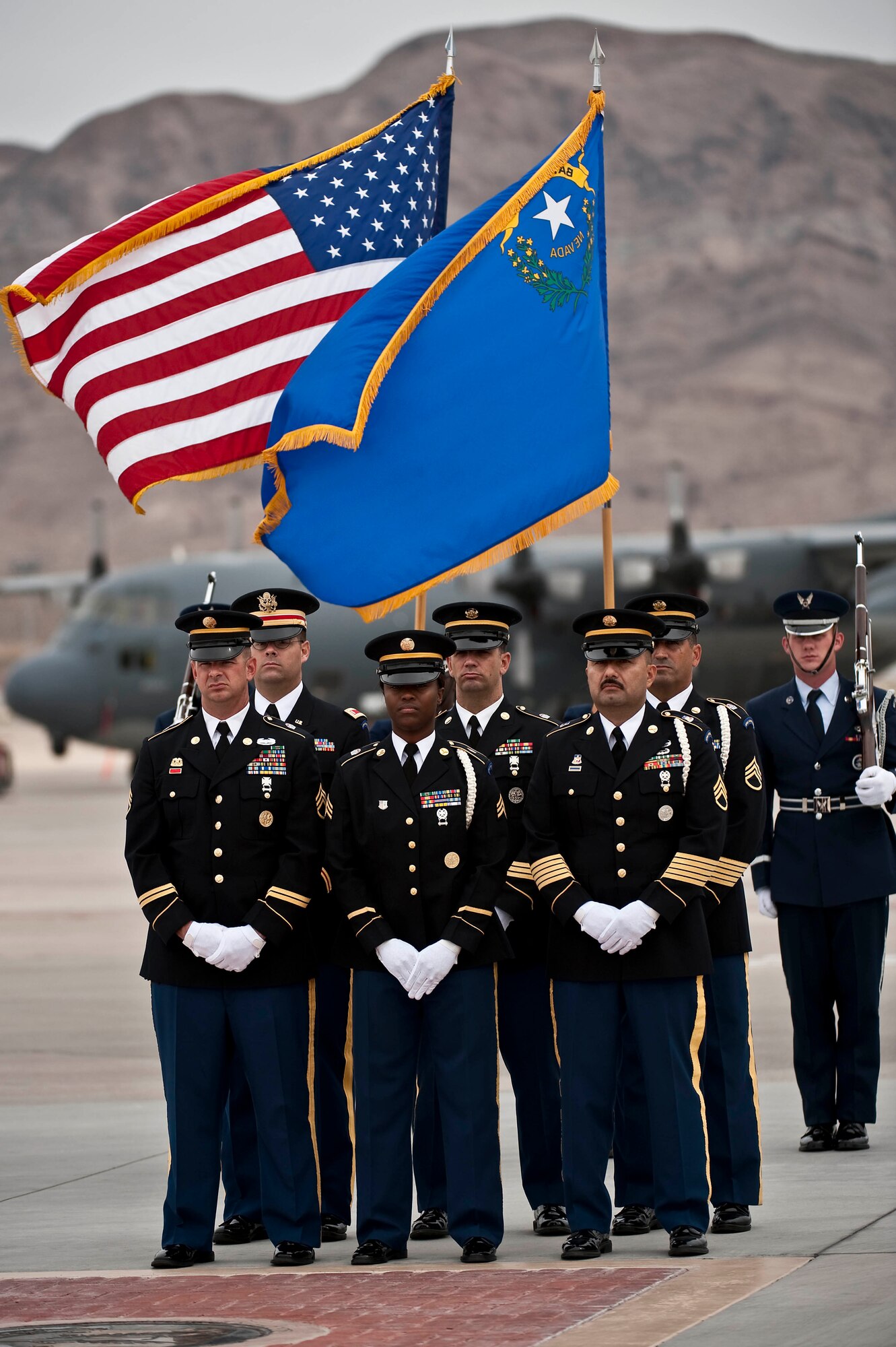 Soldiers and Airmen from the Nevada Army National Guard and Nellis Air Force Base Honor Guard await the arrival of U.S. Army Spc. Dennis James Jr., on the Nellis Air Force Base Nev., flightline Sept. 13, 2011. James was deployed to Afghanistan from the 10th Mountain Division at Fort Polk, La. when he was killed by an improvised explosive device, Aug. 31, 2011. James will be entered into the Southern Nevada Veteran Memorial Cemetery Sept. 26, 2011 at Boulder City, Nev.(U.S. Air Force photo by Tech. Sgt. Michael R. Holzworth/Released)