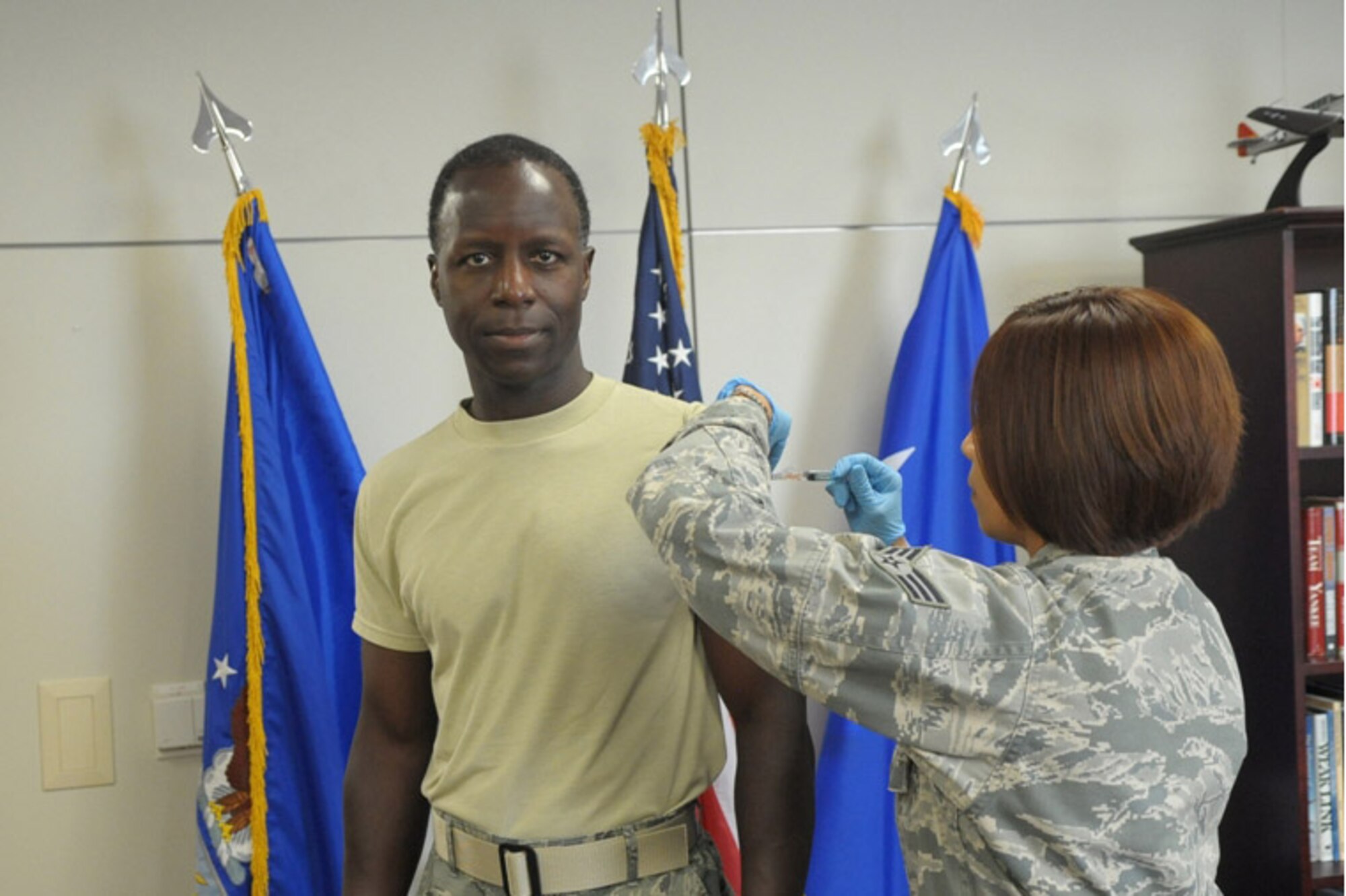 Air Education and Training Command Commander, Gen. Edward A. Rice Jr., received his annual influenza immunization from Senior Airman Jacqueline N. Camposgarcia, 359th Medical Operations Squadron Immunization Clinic journeyman, at Randolph AFB, Aug. 30, 2011. Sheppard AFB will begin flu vaccinations Sept. 19. (Air Force Photo by Joel Martinez)