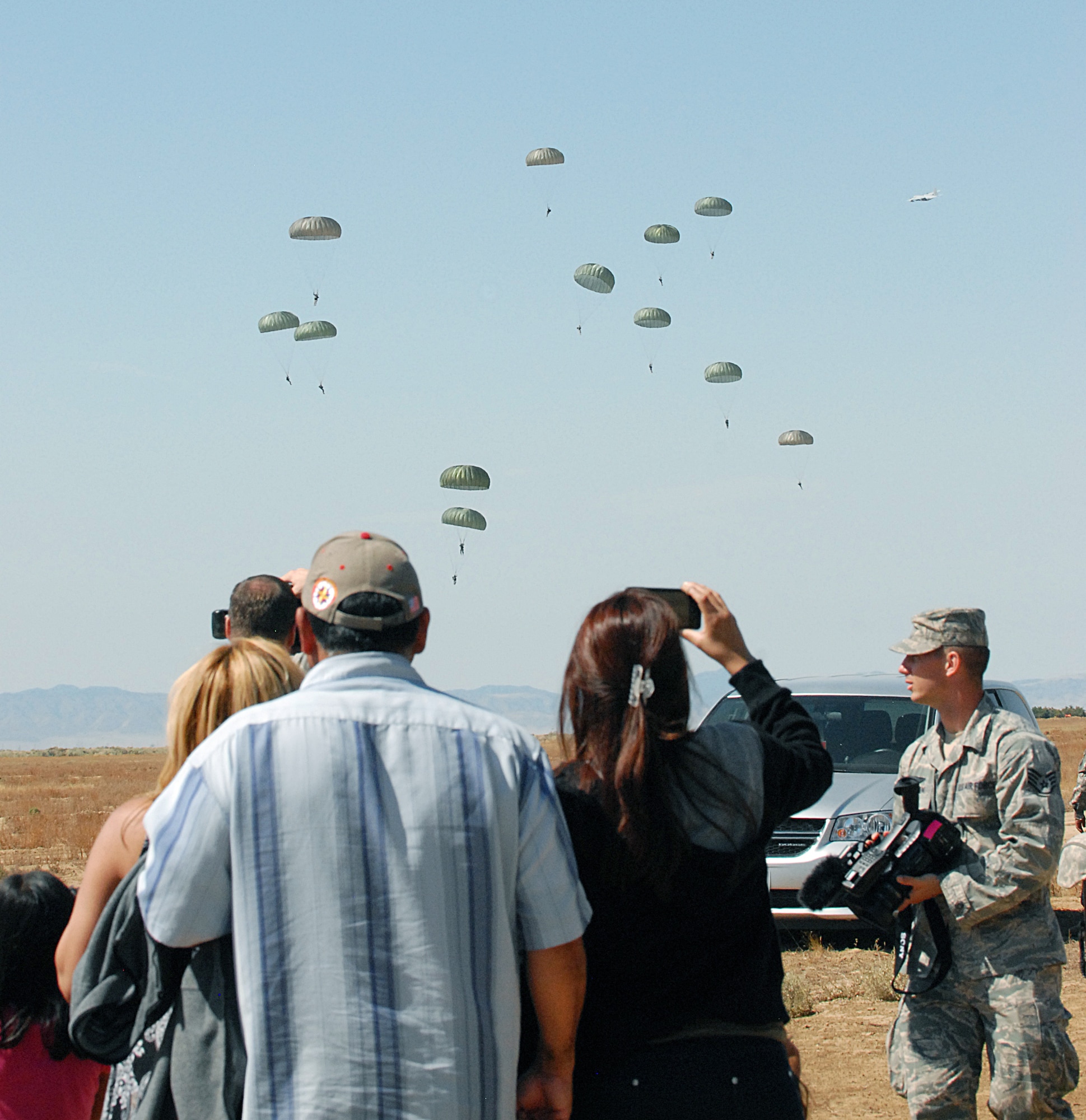 Army paratroopers were joined by friends and family members to commemorate the 10th anniversary of the 9/11 attacks.  About 150 Army paratroopers from three Army Reserve units from California and Texas completed the proficiency jump Sept. 11.  The training event was part of a 9/11 commemorative weekend organized by the 426th Civil Affairs Battalion from Upland, Calif., and the Association of the United States Army Inland Empire Chapter.  (Air Force photos by Kenji Thuloweit) 