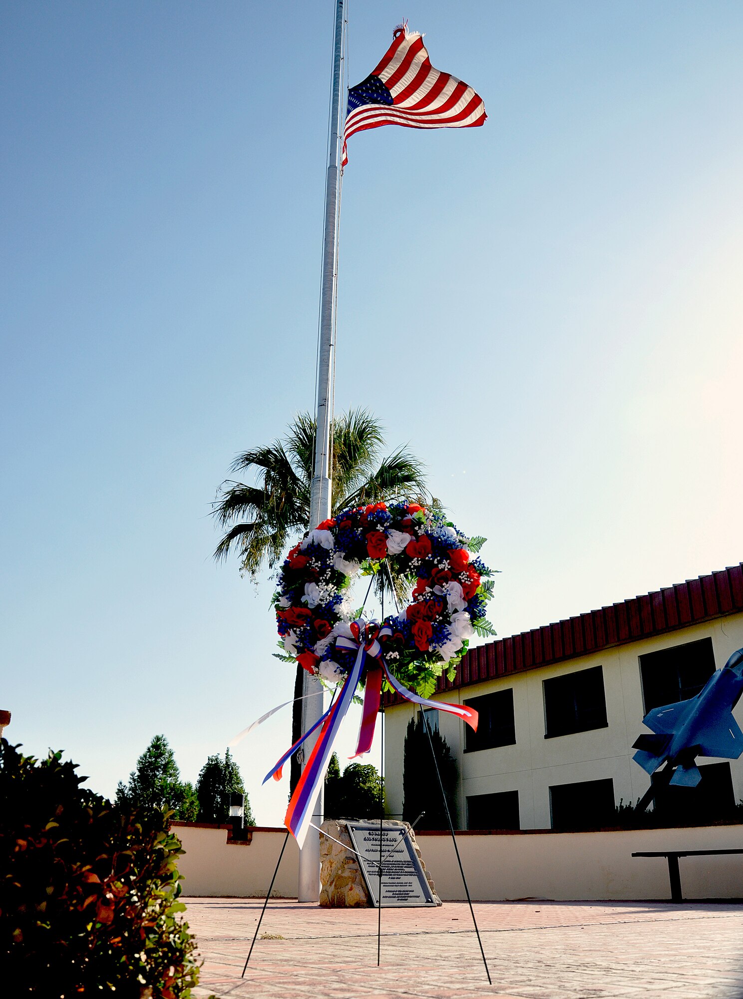 A ceremonial wreath stands in front of the Air Force Flight Test Center headquarters building flag after a remembrance ceremony Sept. 11. Team Edwards joined the nation in remembering the tragic day 10 years ago. (Air Force photo by Mike Strickler)