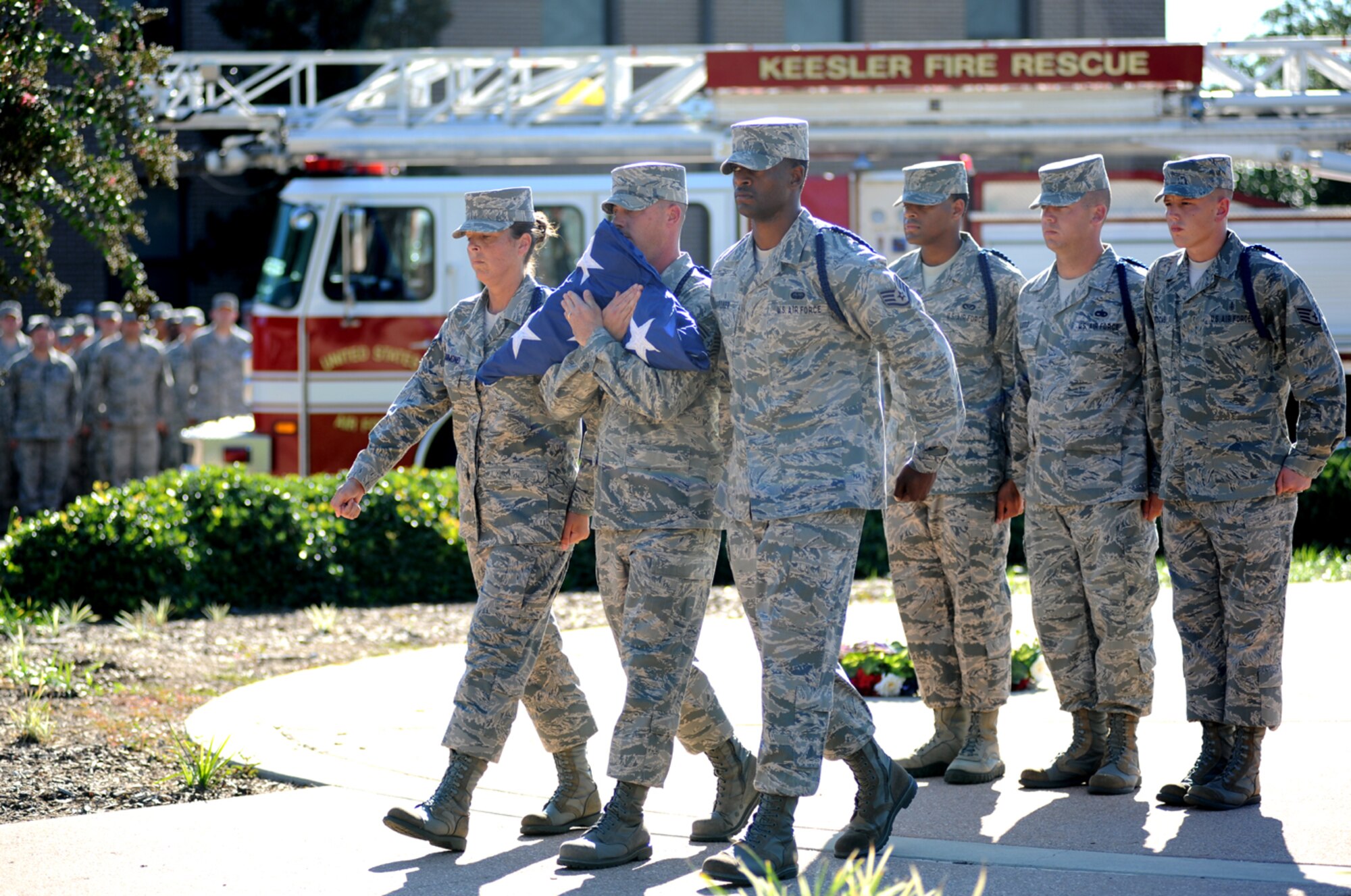 From left, military training leaders Tech. Sgts. Julie Hammond, 81st Training Group,
and James Hoover, 335th Training Squadron, and Staff Sgts. Lamar Gardner, 334th
TRS; Shaundarius Martin and Edward Lotz, 336th TRS; and Jared Whitcomb, 338th TRS, march with the folded flag after formal retreat Sept. 9.  (U.S. Air Force photo by Kemberly Groue)
