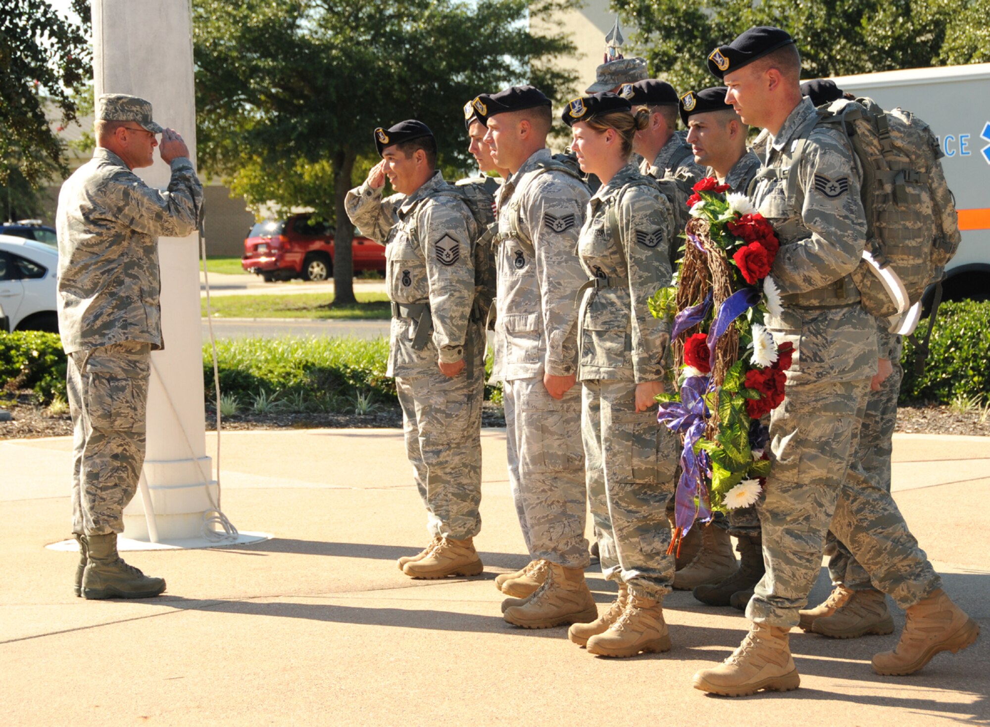 From left, Brig. Gen. Andrew Mueller, 81st Training Wing commander, returns a salute
from Master Sgt. Daniel Fuentes Sr. as he and other 81st Security Forces Squadron members prepare to place a wreath at the flagpole in front of wing headquarters during formal retreat ceremony Sept. 9. The nine-member Keesler team marched 148 miles of the 2,181-mile Air Force Security Forces 9/11 Ruck March to Remember from Lackland Air Force Base, Texas, through Shanksville, Pa., to Ground Zero for Sunday’s 9/11 observance.  (U.S. Air Force photo by Kemberly Groue)