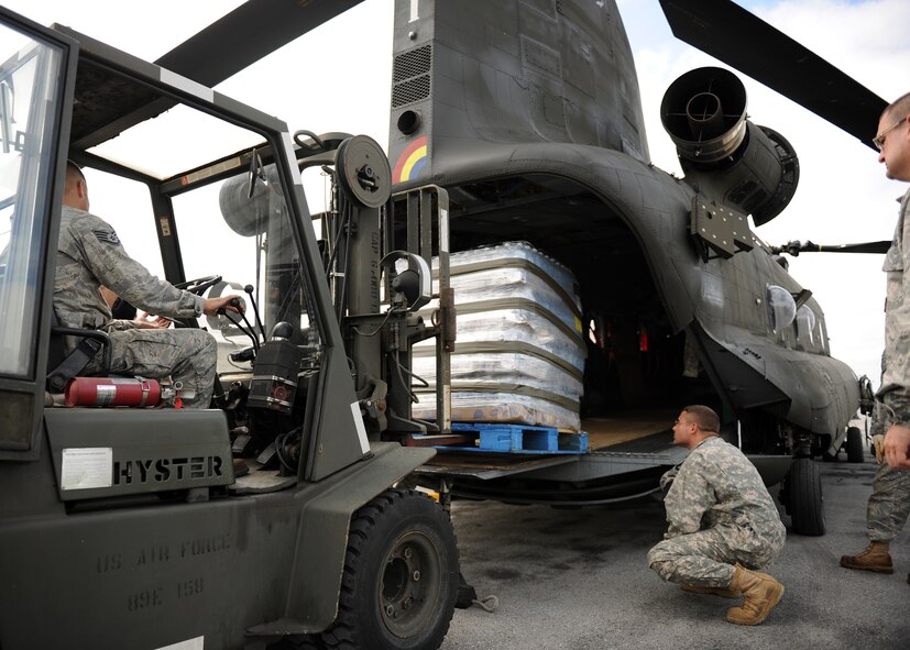 Members of Hancock Field Air National Guard Base, Syracuse New York load supplies into a New York Army National Guard Chinook helicopter in support of Federal Emergency Management Agency (FEMA) operations in flood ravaged Binghamton New York on Sept 9, 2011.  FEMA established its operations center at Hancock Field where they worked hand-in-hand with New York’s Army and Air Guard.  (U.S. Air Force photo by Staff Sgt. Ricky Best) 