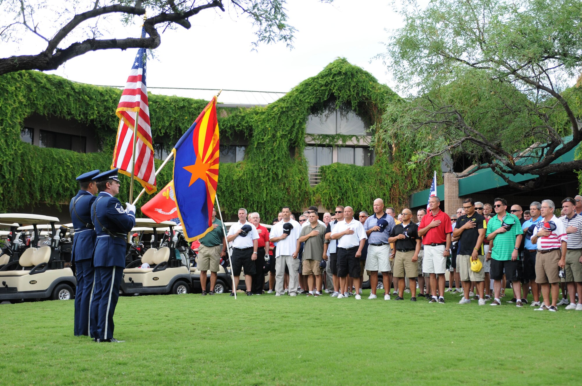 Staff Sgt. Jose Toro, left, and Master Sgt. Frank Enfinger, members of the 162nd Fighter Wing Honor Guard based at Tucson International Airport, present the colors at the start of the second annual Patriot Golf Day Tournament at Ventana Canyon Country Club, Sept. 12. More than 170 Airmen from the Arizona Air Guard and from Davis Monthan Air Force Base along with several community members, participated to raise funds for military charities. (U.S. Air Force photo/Maj. Gabe Johnson)