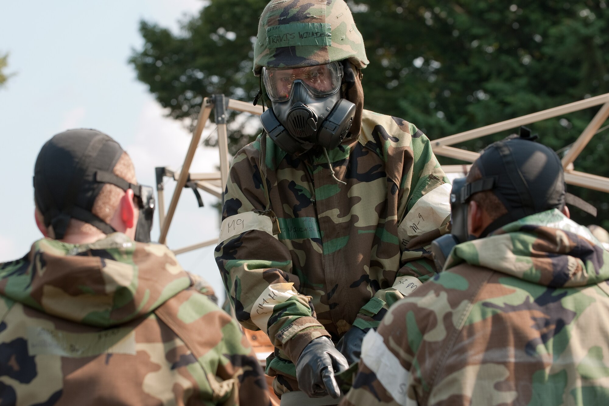 YOKOTA AIR BASE, Japan -- Airman 1st Class Travis Wilkinson, 374th Communications Squadron, instructs Airmen to process safely through a Contamination Control Area at Yokota Air Base, Japan, Sept. 14, 2011 during a wing readiness exercise. (U.S. Air Force photo/Osakabe Yasuo)