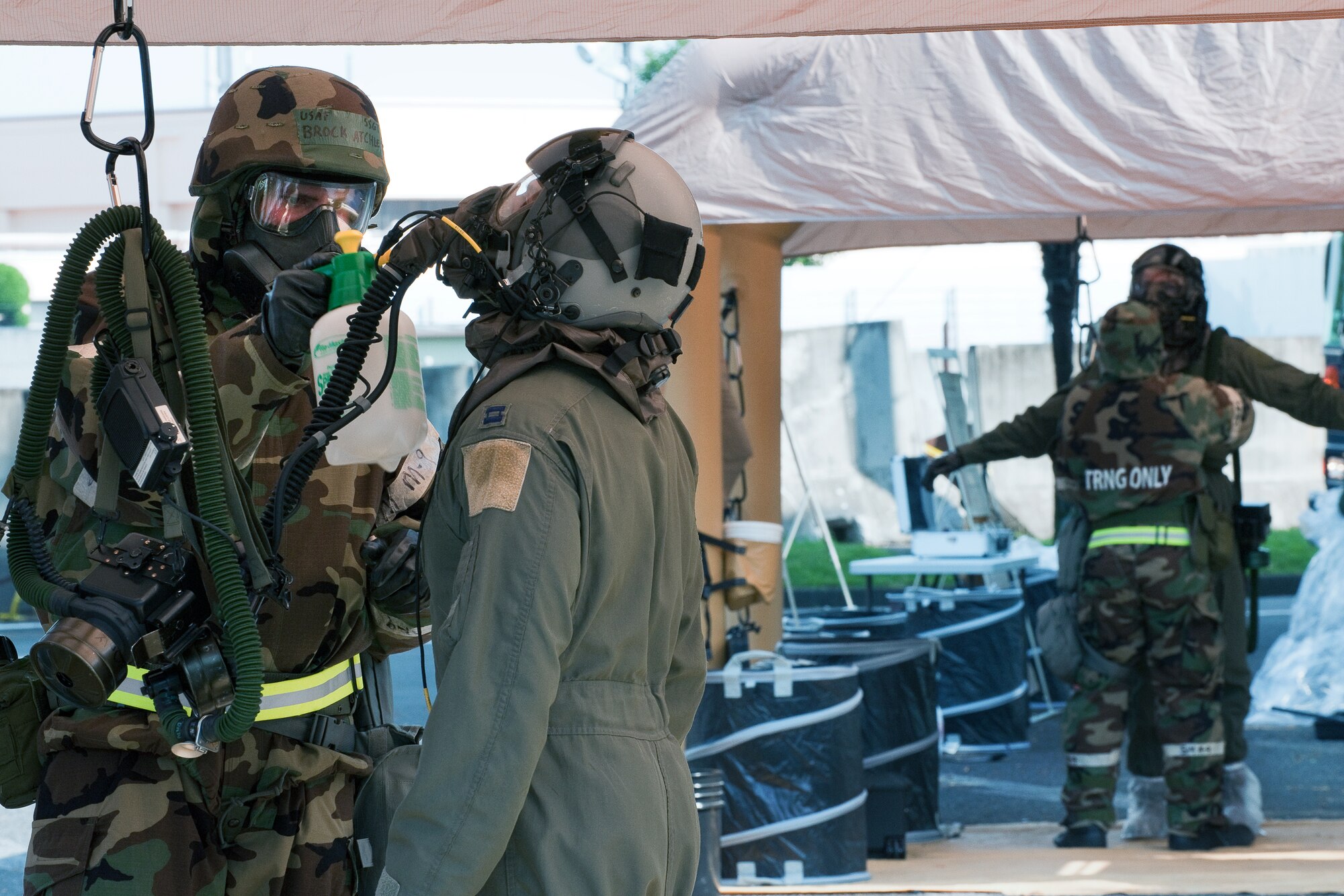 YOKOTA AIR BASE, Japan -- Staff Sgt. Brock Atchley, 374th Operations Support Squadron, performs a chemical decontamination procedure on a simulated contaminated aircrew member at Yokota Air Base, Japan, Sept. 14, 2011 during a wing readiness exercise. (U.S. Air Force photo/Osakabe Yasuo)  	