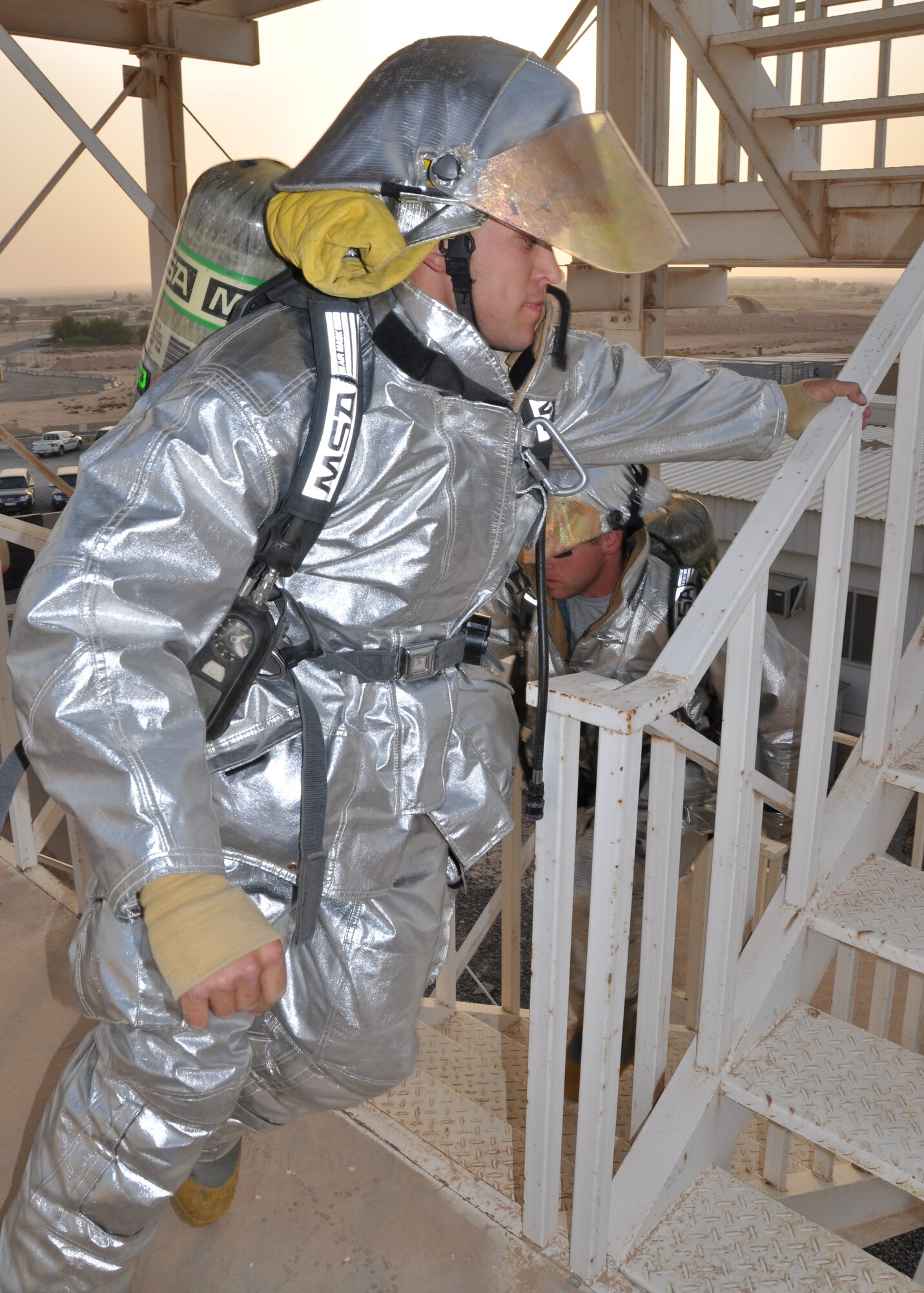 Staff Sgt. Adrian Angelovic and Staff Sgt. Stentson Ellenburg, 386th Expeditionary Civil Engineer Squadron firefighters, participate in the “Climb to Remember” Sept. 11 at an undisclosed location in Southwest Asia. (U.S. Air Force phot by Senior Airman Rachelle Elsea)