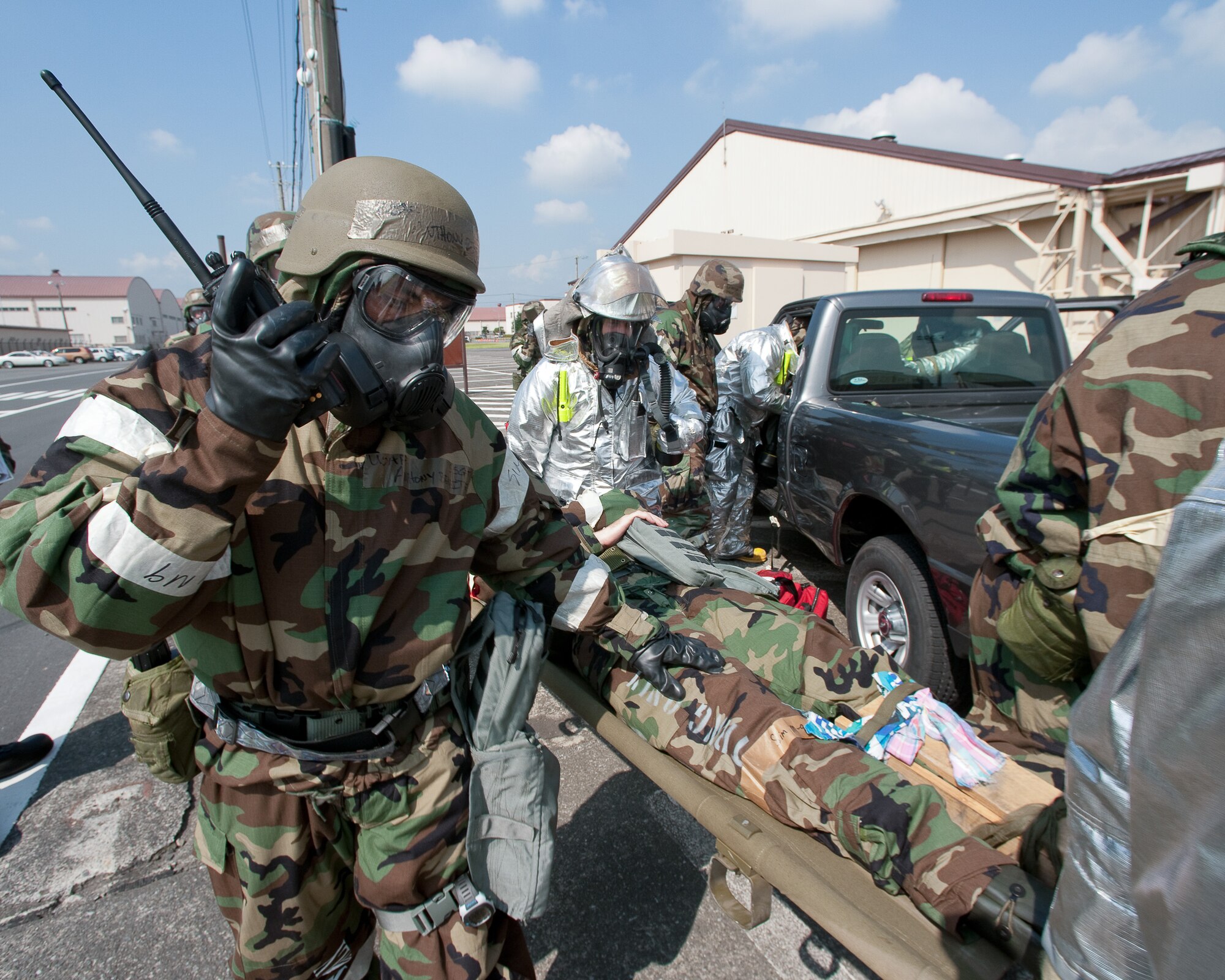 YOKOTA AIR BASE, Japan -- Staff Sgt. Anthony Benitez (left), 374th Maintenance Squadron, reports to the Unit Control Center after performing SABC at Yokota Air Base, Japan, Sept. 13, 2011. The 374th MXS demonstrated their skills during a wing readiness exercise. (U.S. Air Force photo/Osakabe Yasuo)
