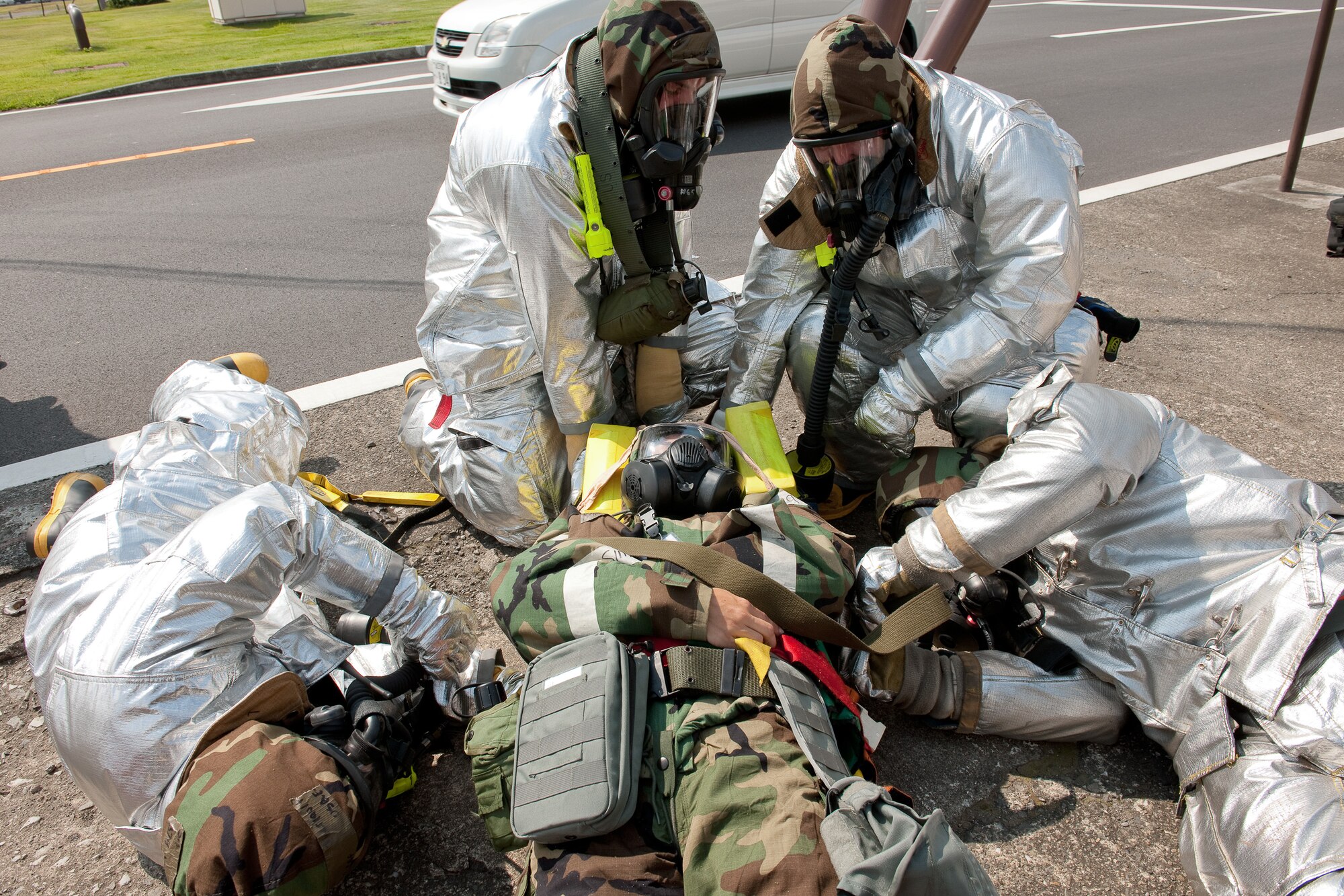 YOKOTA AIR BASE, Japan -- Yokota firefighters perform immobilization procedures on a simulated contaminated environment at Yokota Air Base, Japan, Sept. 14, 2011 during a wing readiness exercise. (U.S. Air Force photo/Osakabe Yasuo)