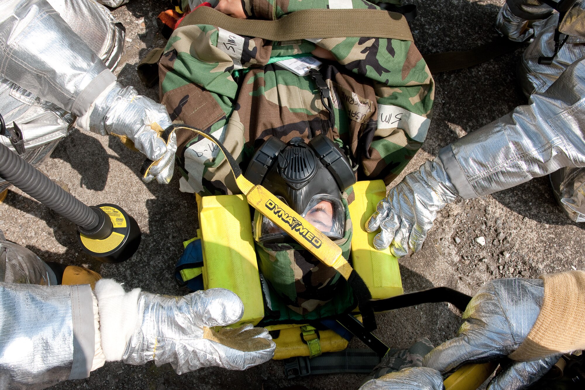 YOKOTA AIR BASE, Japan -- Yokota firefighters perform immobilization procedures on a simulated contaminated environment at Yokota Air Base, Japan, Sept. 14, 2011 during a wing readiness exercise. (U.S. Air Force photo/Osakabe Yasuo)