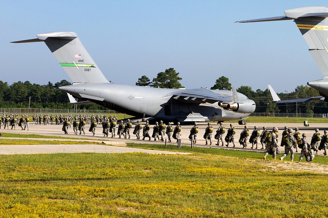 Army paratroopers load into C-17 Globemaster III aircraft for a mass-tactical airborne training operation on Pope Field near Fort Bragg, N.C., Sept. 10, 2011.