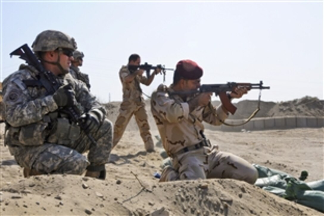 U.S. Army paratroopers and Iraqi soldiers fire at paper targets with a variety of weapons during the opening of the Anbar Operation Center's new range in Ramadi, Iraq, Sept 10,  2011. The U.S. soldiers are assigned to the 82nd Airborne Division's 1st Battalion, 325th Airborne Infantry Regiment, 2nd Advise and Assist Brigade.