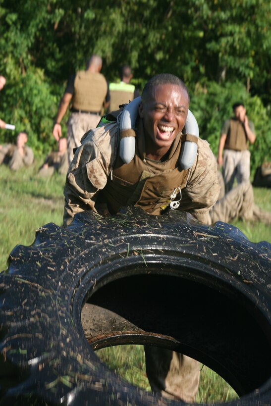 Sgt. Terrell L. Pryor, an administrative clerk with the Marine Forces Reserve Installation Personnel Administration Center, flips a tire across a field during the final event of the Marine Corps Martial Arts Instructor Course here, Sept. 14, 2011. The 15-day course prepared the Marines for the rigorous final event in which they endured eight hours of combat conditioning, ground fighting, and hiking more than six miles with a full combat load. The tire flip was one of the many combat conditioning exercises the Marines performed.