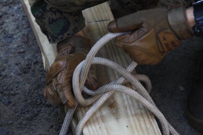 Lance Cpl. Jonathan Black, a fireteam leader with 2nd Platoon, Charlie Company, 1st Battalion, 2nd Marine Regiment, ties wooden planks together during a leadership training exercise at the Leadership Reaction Course on Fort Pickett, Va., Sep. 14, 2011. More than 900 Marines and Sailors are taking part in the Deployment for Training exercise at Fort Pickett, Sept. 6-23. The battalion is scheduled to attach to the 24th Marine Expeditionary Unit as its Battalion Landing Team a few days after the training.