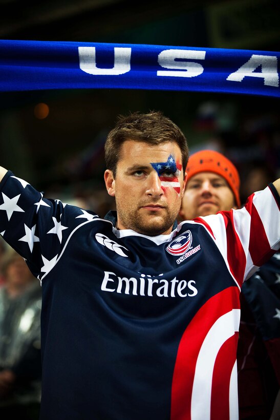 A USA Eagles fan holds up his USA scarf while the national anthem is played at the U.S. versus Russia match during the Rugby World Cup 2011 at Stadium Taranaki here Sept. 15. The MARFORPAC band is in New Zealand to kick off a yearlong celebration to commemorate the 70th anniversary of Marines landing in Wellington in 1942. (Official U.S. Marine Corps photo by Lance Cpl. Isis M. Ramirez)